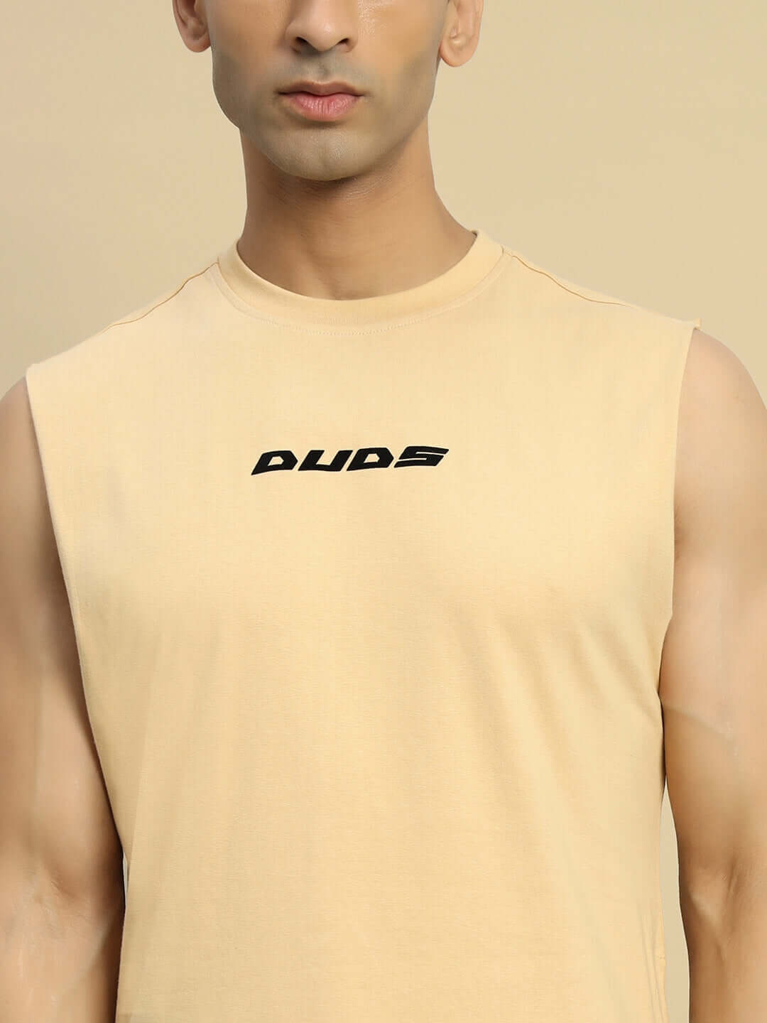 Model wearing beige VERTEX relaxed fit sleeveless T-shirt by DUDS.