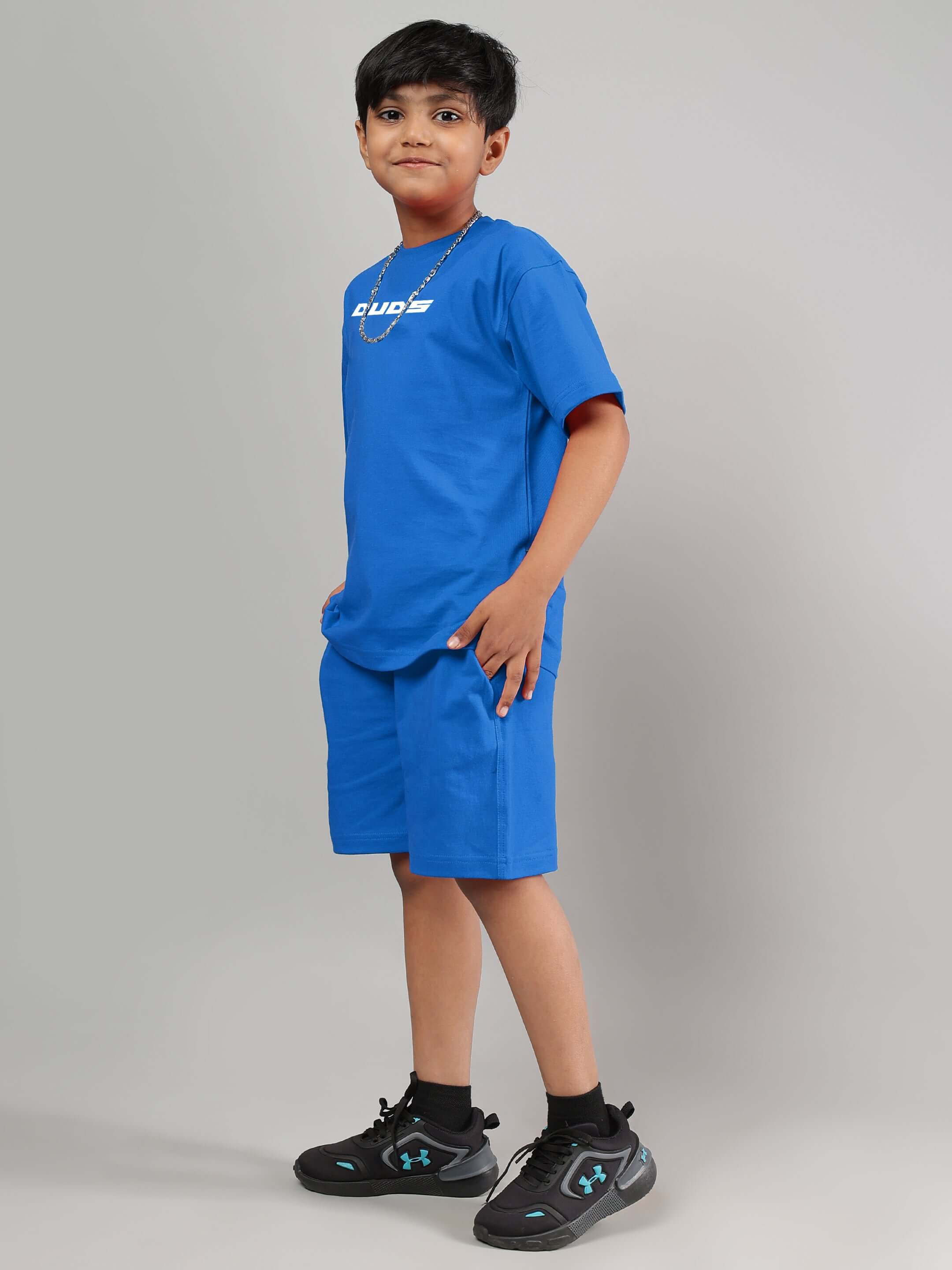 Boy wearing Victory Co-ord in royal blue by DUDS, featuring matching shirt and shorts, perfect for casual or sporty occasions.