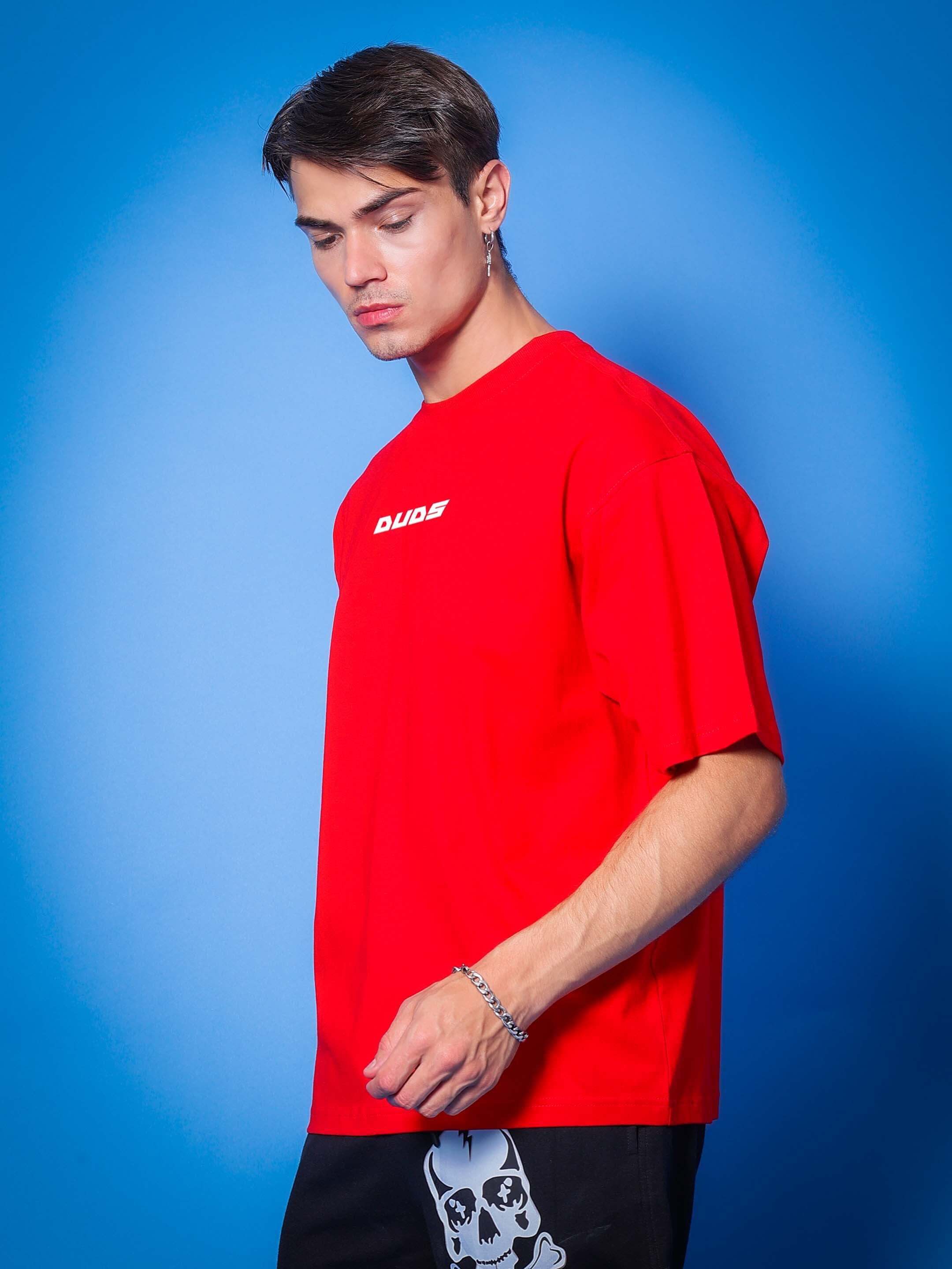 Model wearing Victory Oversized Red T-Shirt from DUDS, showcasing casual style with custom fit option for a personalized look.