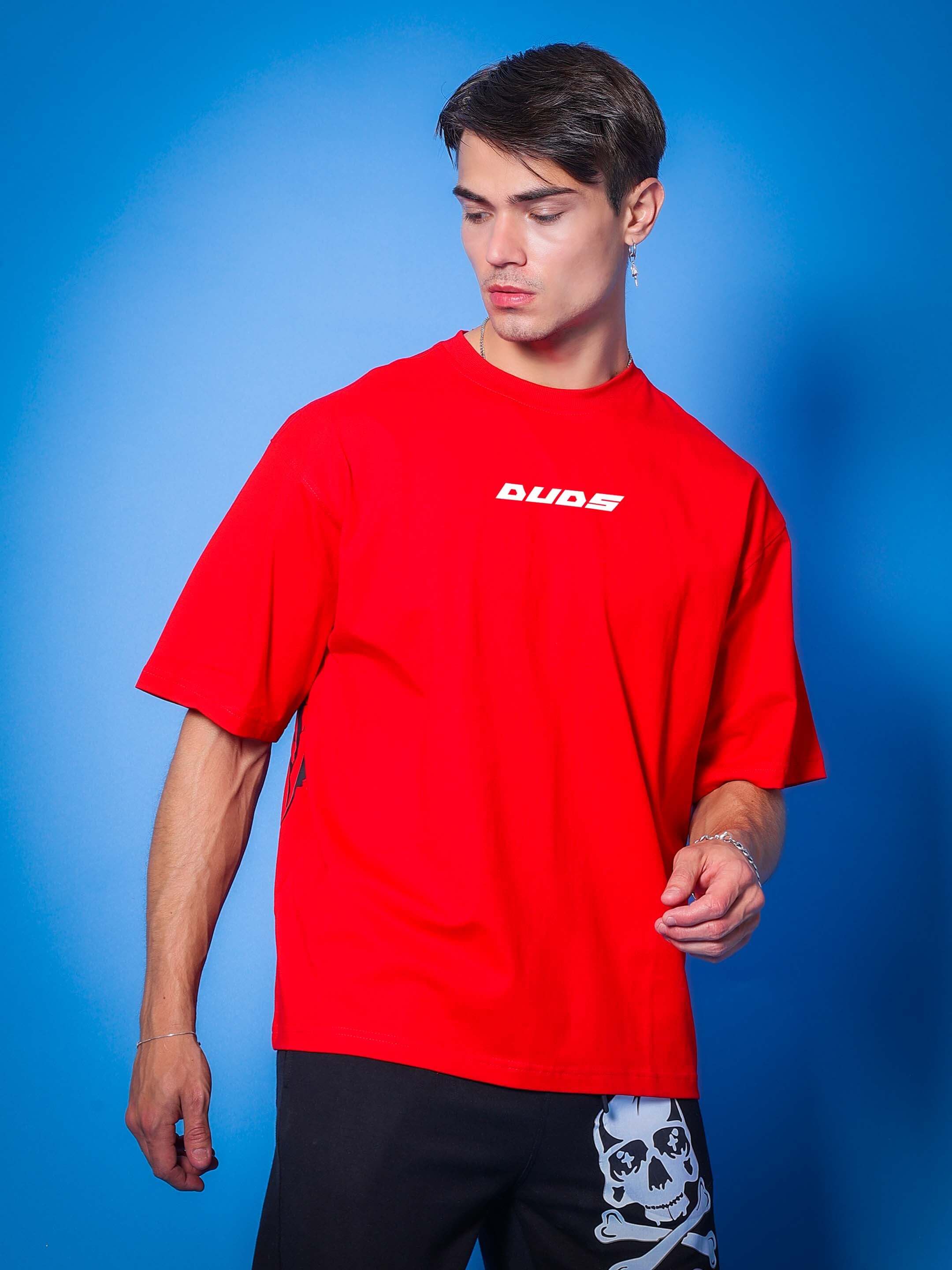 Model wearing VICTORY over-sized red t-shirt by DUDS, featuring comfortable fit and custom size options for prepaid orders.
