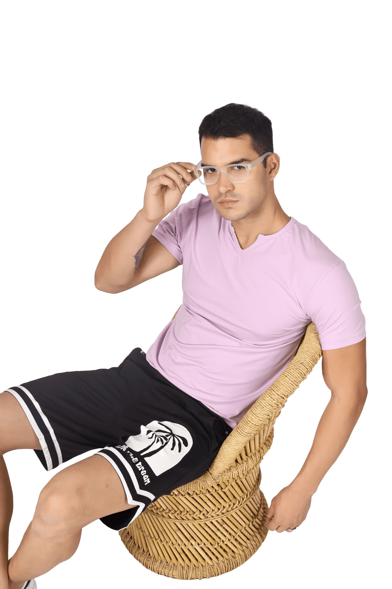 Man wearing VIKING REGULAR FIT T-SHIRT LILAC sitting on a wicker chair, showcasing modern style and comfort.