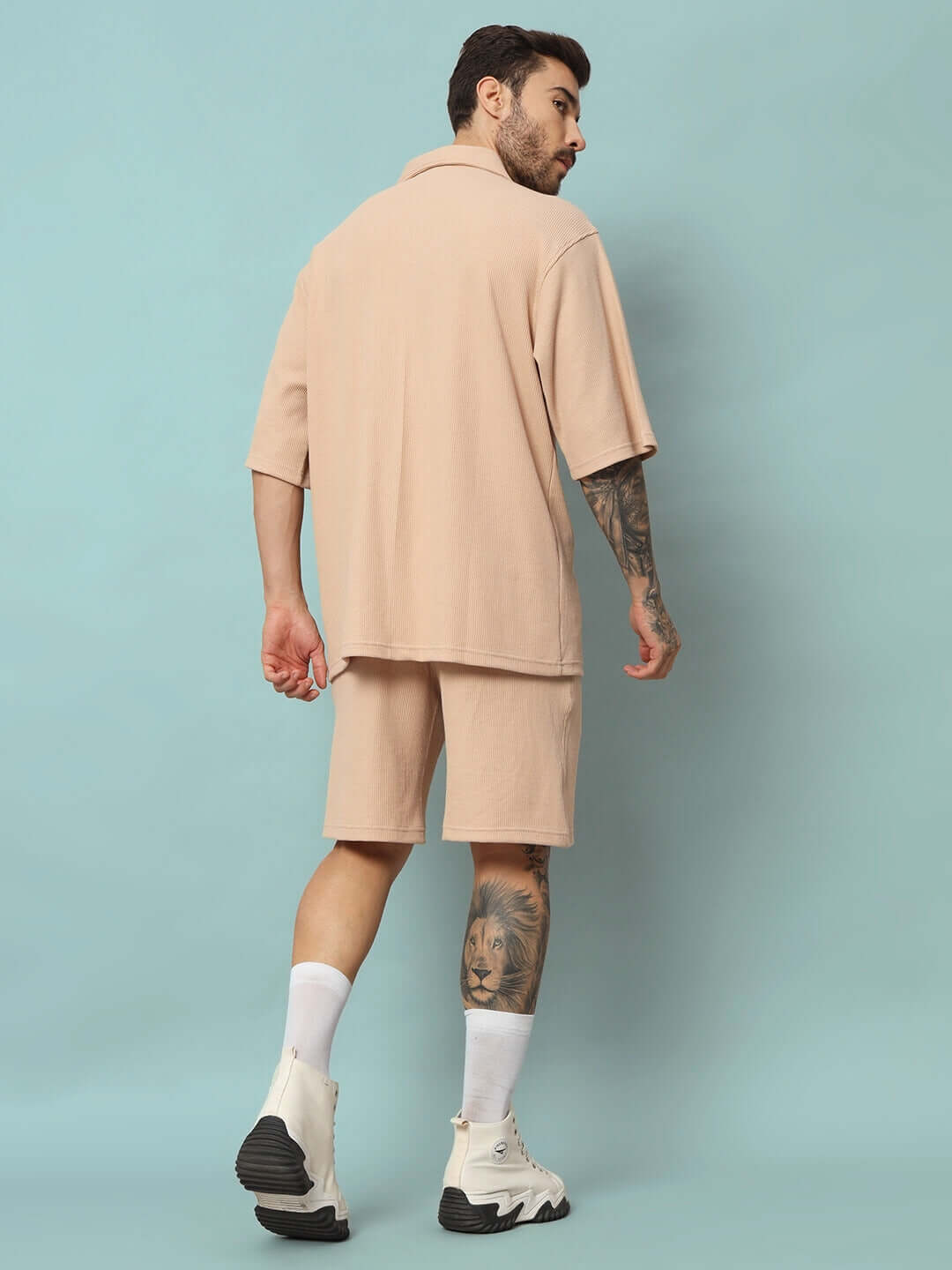 Man wearing a beige waffle solid resort shirt co-ord set, showcasing relaxed fit and half sleeves, made from 100% cotton fabric.
