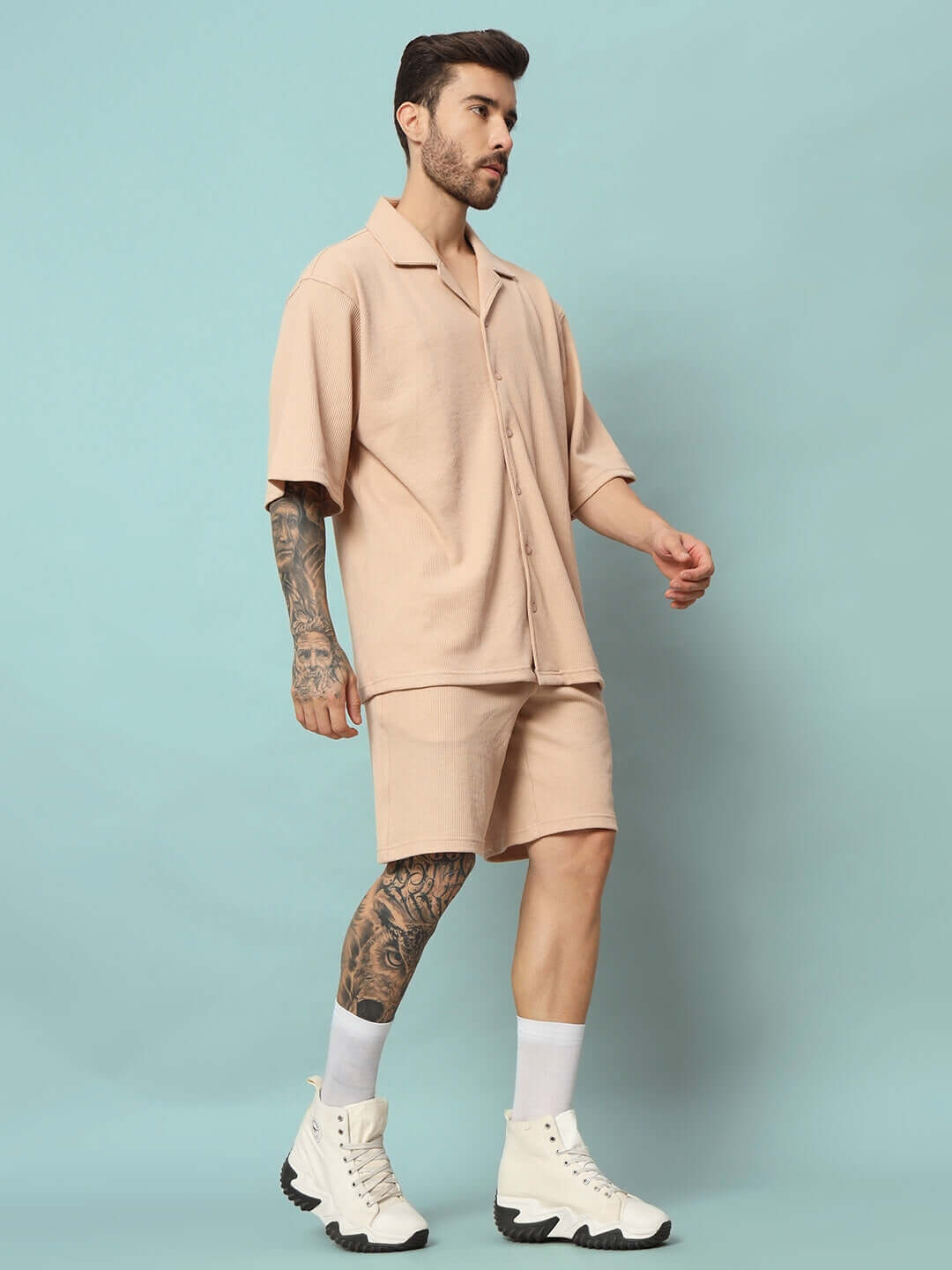 Man wearing WAFFLE SOLID RESORT SHIRT CO-ORD SET BEIGE in front of a blue background, showcasing lightweight resort wear.