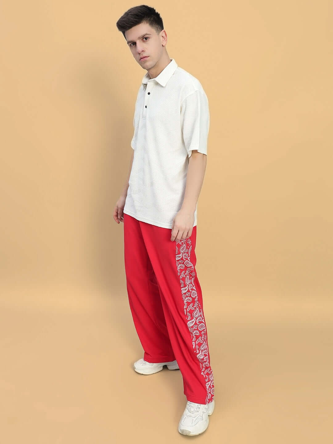 Model wearing red Waltz Relaxed Fit Joggers by DUDS. Made to order with custom fit option. Shipping takes 7-10 days.