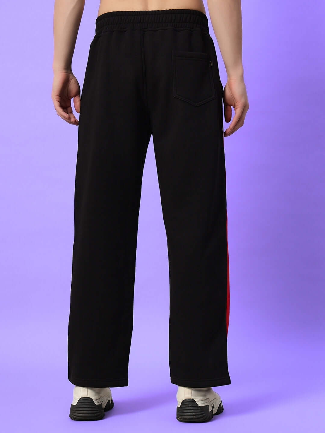 Back view of black-red WD Fireball Colorblock Cargo Pants on a purple background