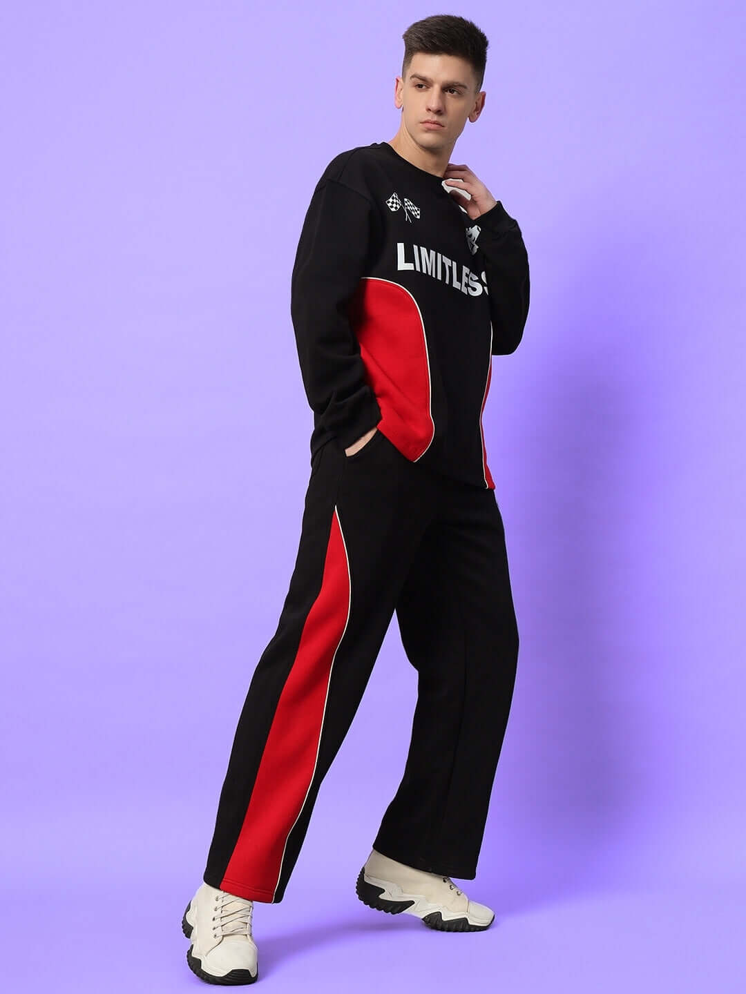Man wearing WD Fireball colorblock cargo pants in black-red, featuring bold side stripes, paired with a matching black top.