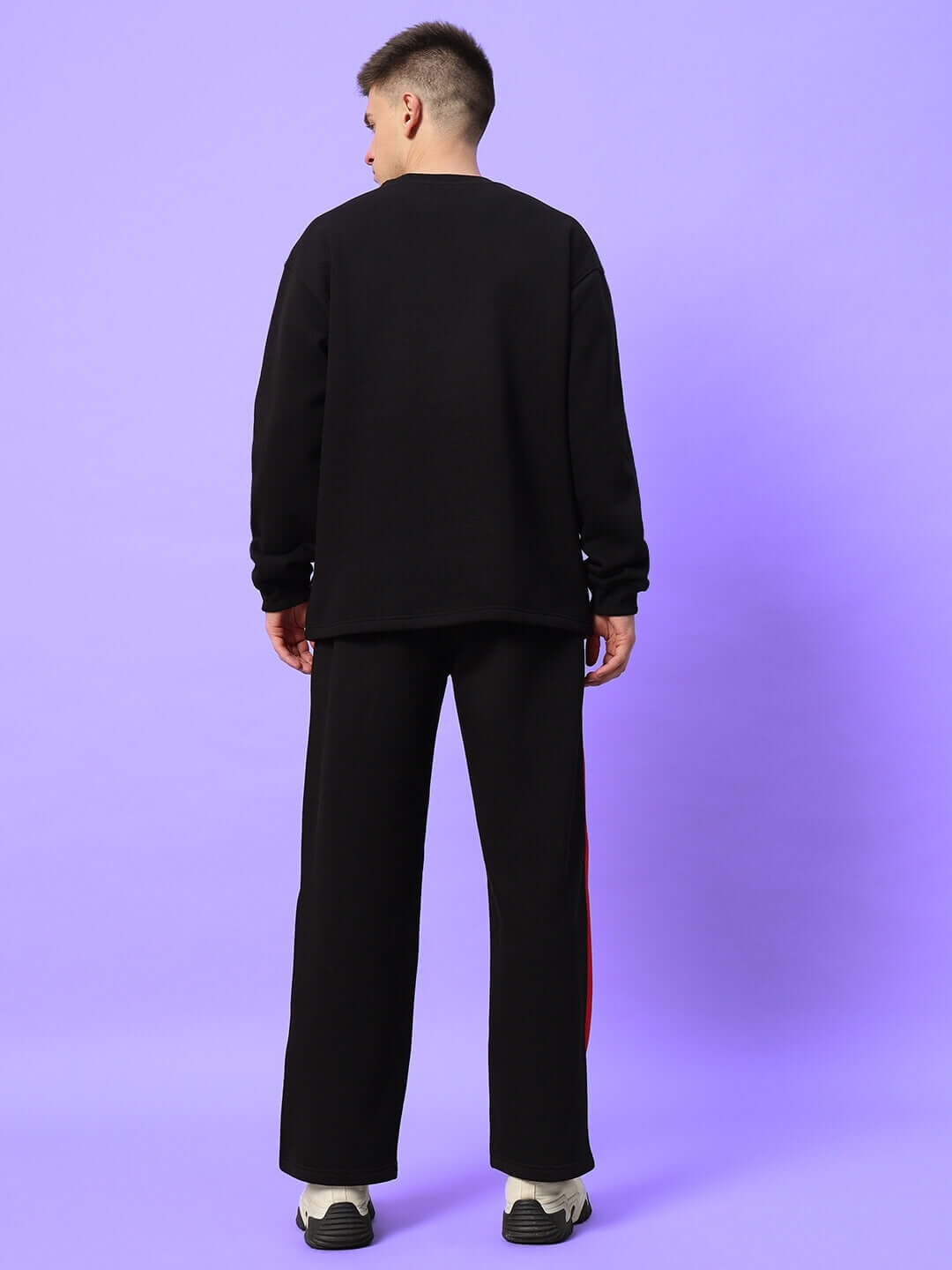 Rear view of model wearing WD FIREBALL COLORBLOCK CO-ORD BLACK RED, featuring black-red design, premium fabric, streetwear style.