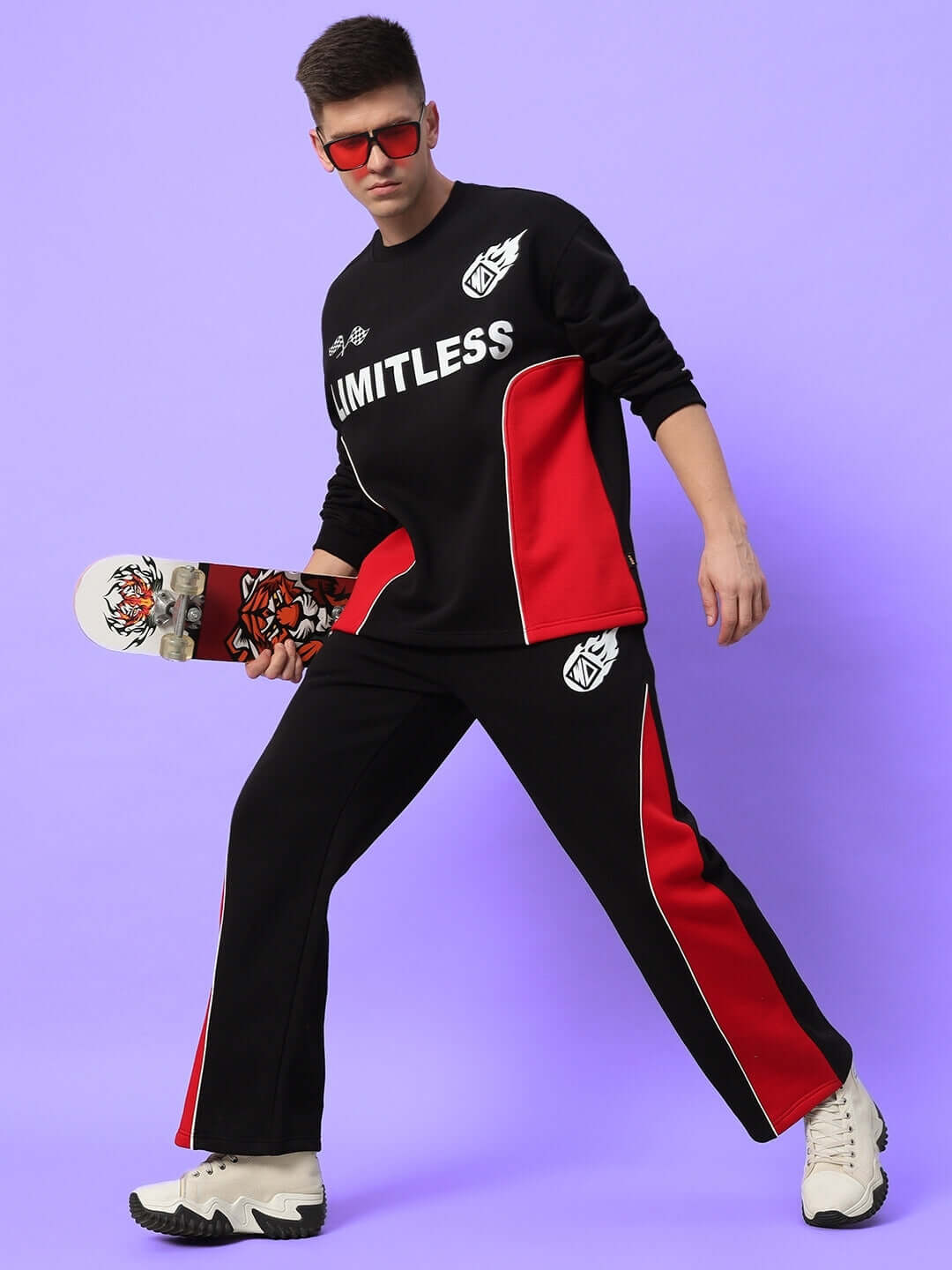 Model wearing WD FIREBALL COLORBLOCK CO-ORD BLACK RED with skateboard, featuring stylish black-red design for streetwear fashion.