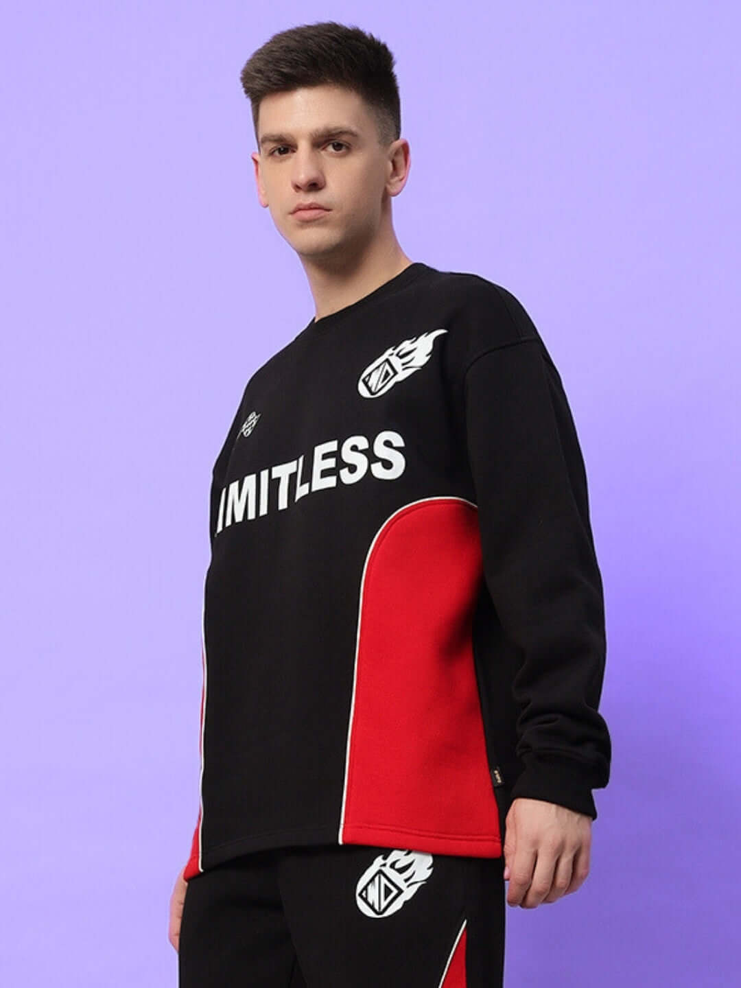 Model wearing WD FIREBALL COLORBLOCK CO-ORD BLACK RED with bold streetwear design against a purple background.
