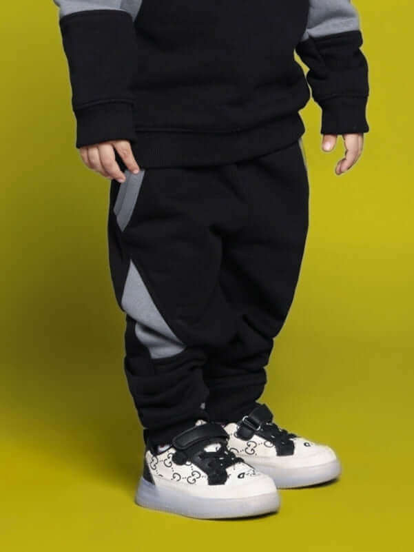 WD Gorpcore Fleece Colorblock Pant for Kids in black and gray, made to order by DUDS with custom fit options. Comfortable and stylish design.