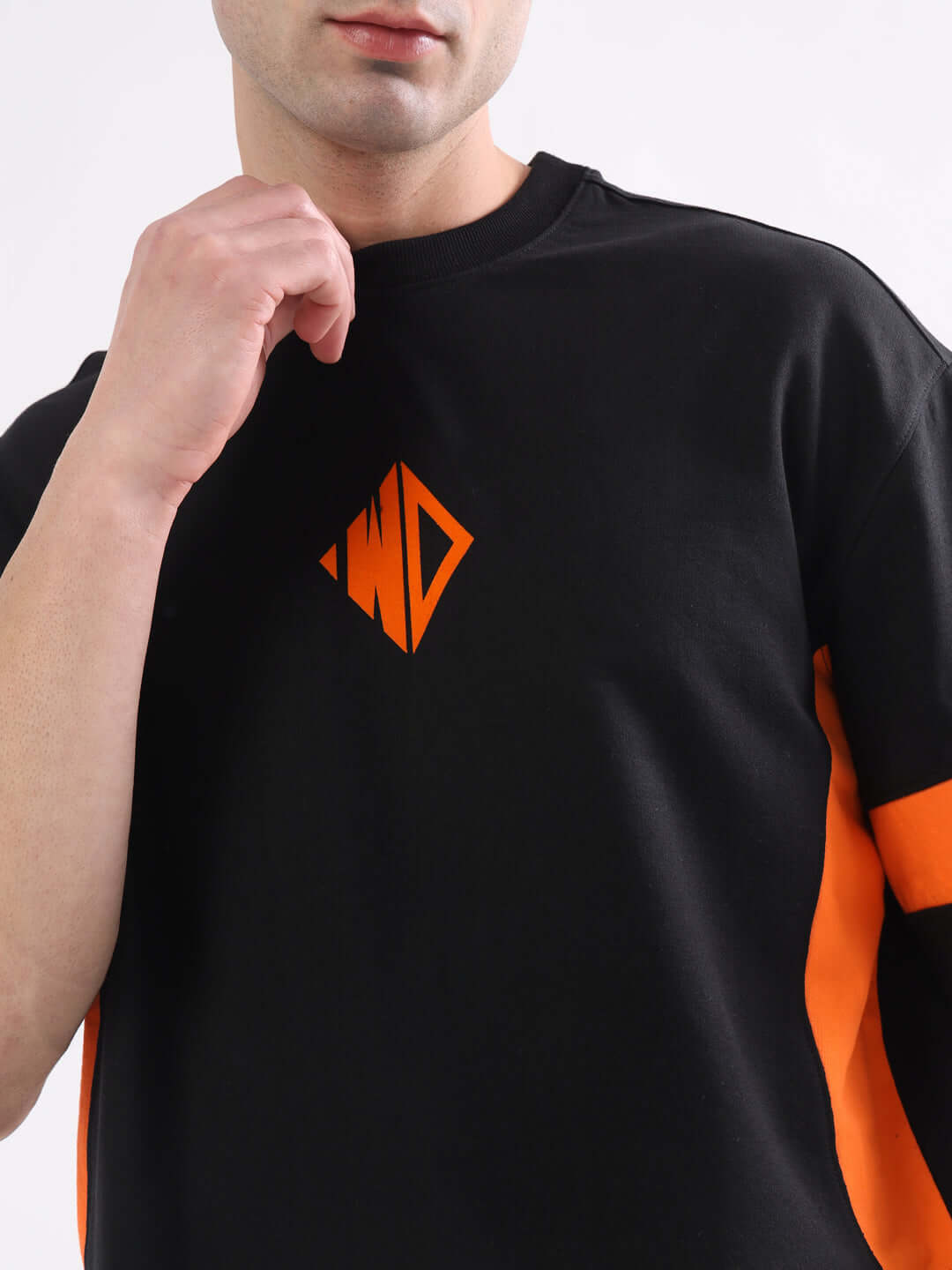 Model wearing WD Gorpcore oversized T-shirt in black and orange, featuring premium cotton fabric, designed for comfort.