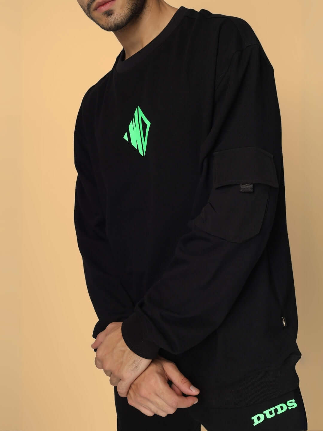 Model wearing black oversized co-ord set with green neon WD logo, featuring relaxed fit joggers and a box pocket, ideal for casual wear.