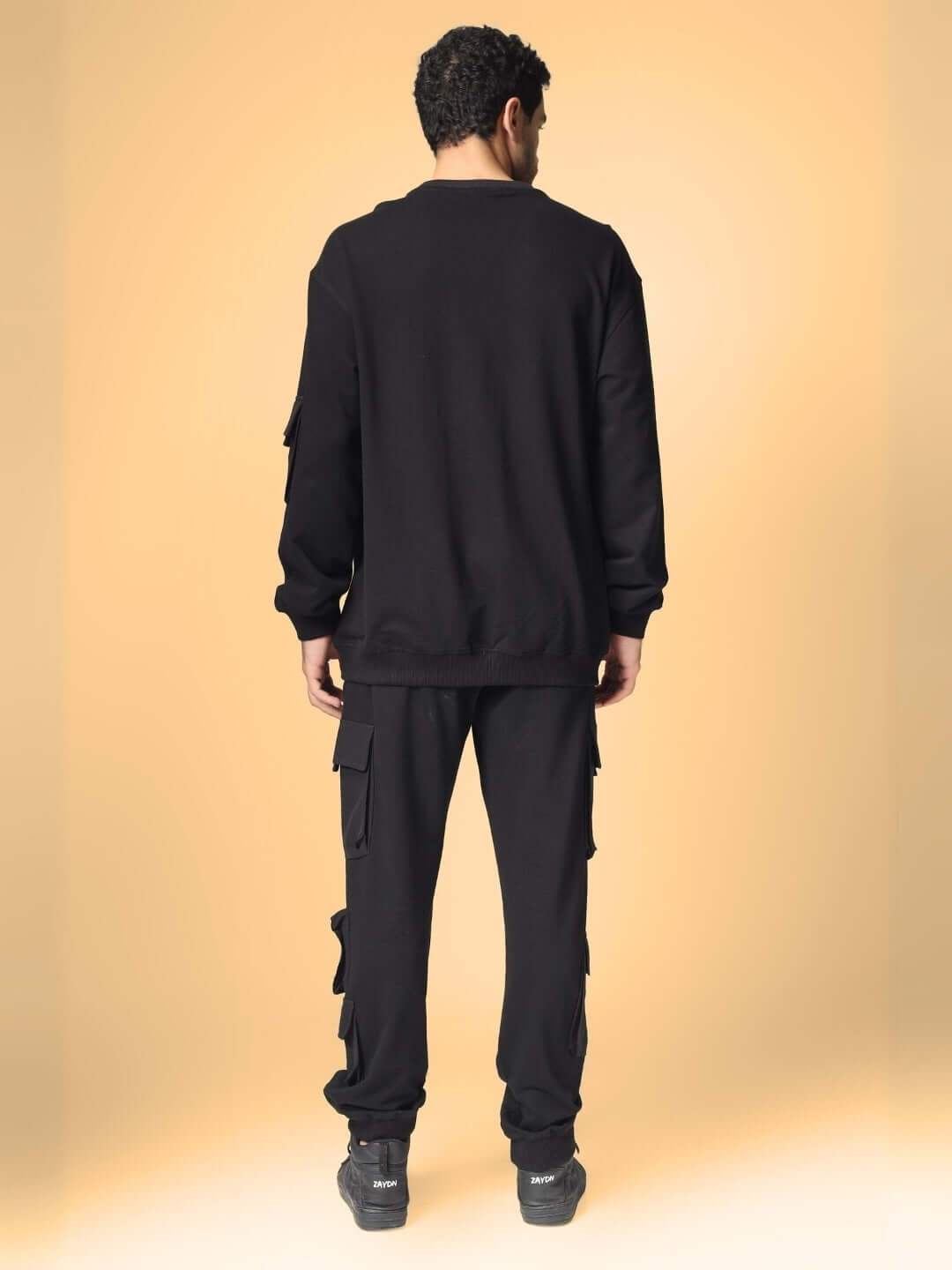 Back view of black WD Oversized Co-Ord Set with relaxed fit joggers, elasticated waistband, and box pocket cargo design.