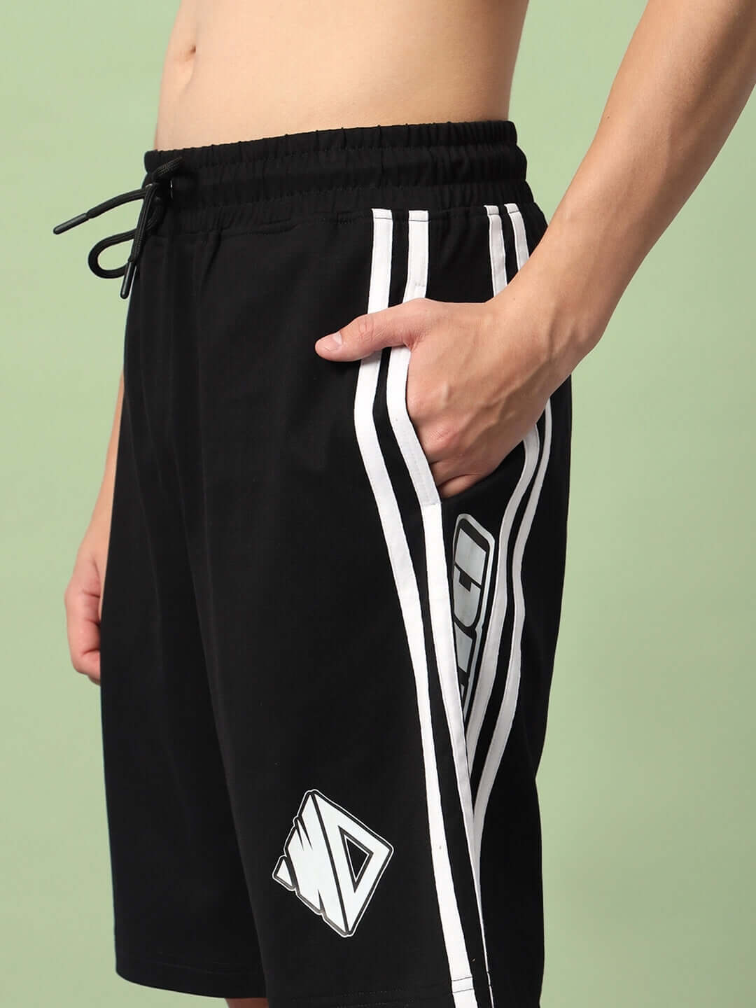 Man wearing WD Premium Regular Fit Black Shorts with white stripes and logo, showcasing relaxed style. Ideal for custom fit options.