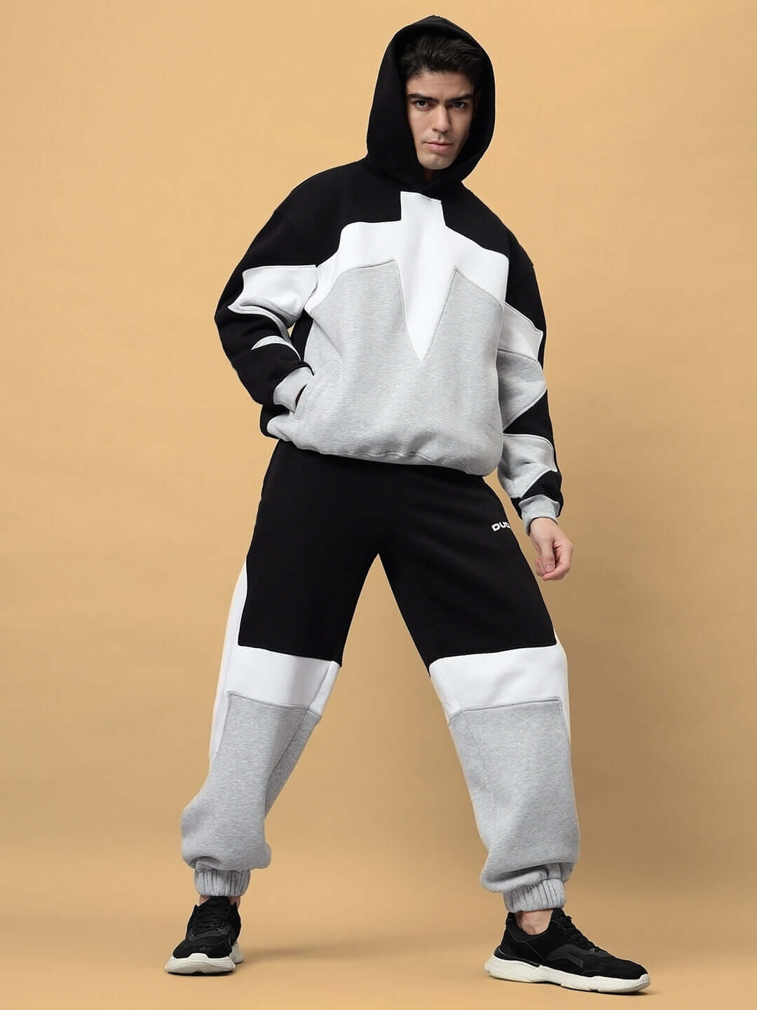 Model wearing WD Sword Fleece Colorblock Cargo Pant with bold panels, elastic waistband, and ribbed cuffs for modern streetwear style.
