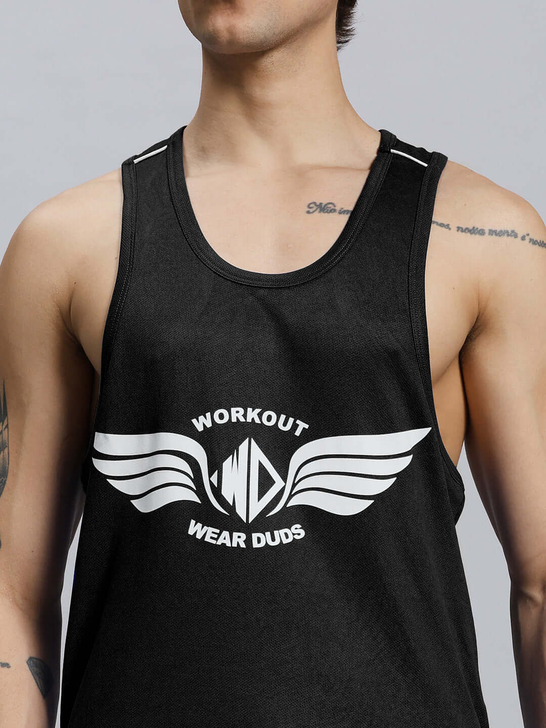 Man wearing WD WINGS GYM CO-ORD SET MEN BLACK tank top with wings detailing, showcasing modern athletic fit and style.