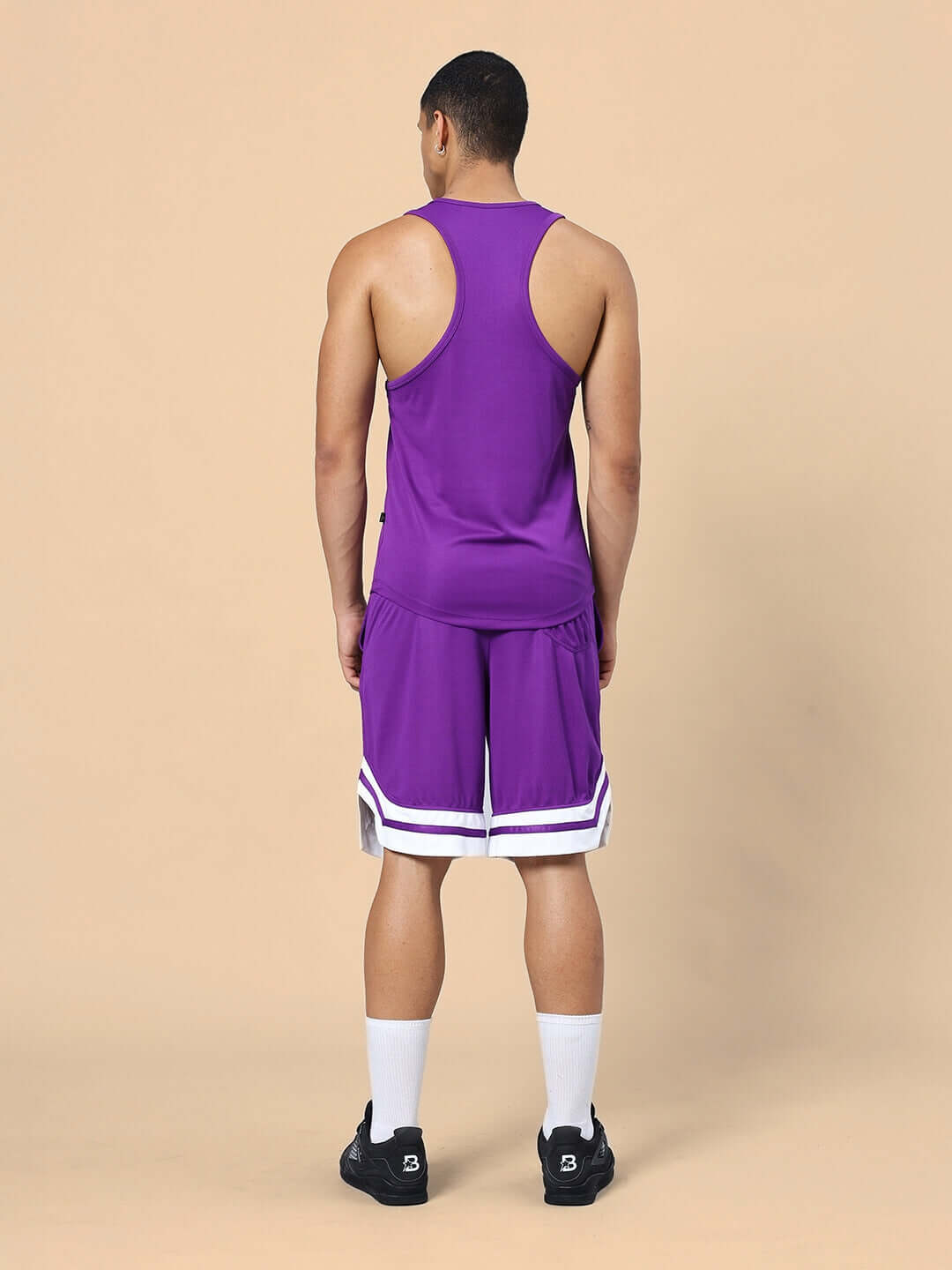 Back view of a man wearing WD WINGS GYM CO-ORD SET PURPLE, featuring a tank top and matching shorts for fitness style and comfort.