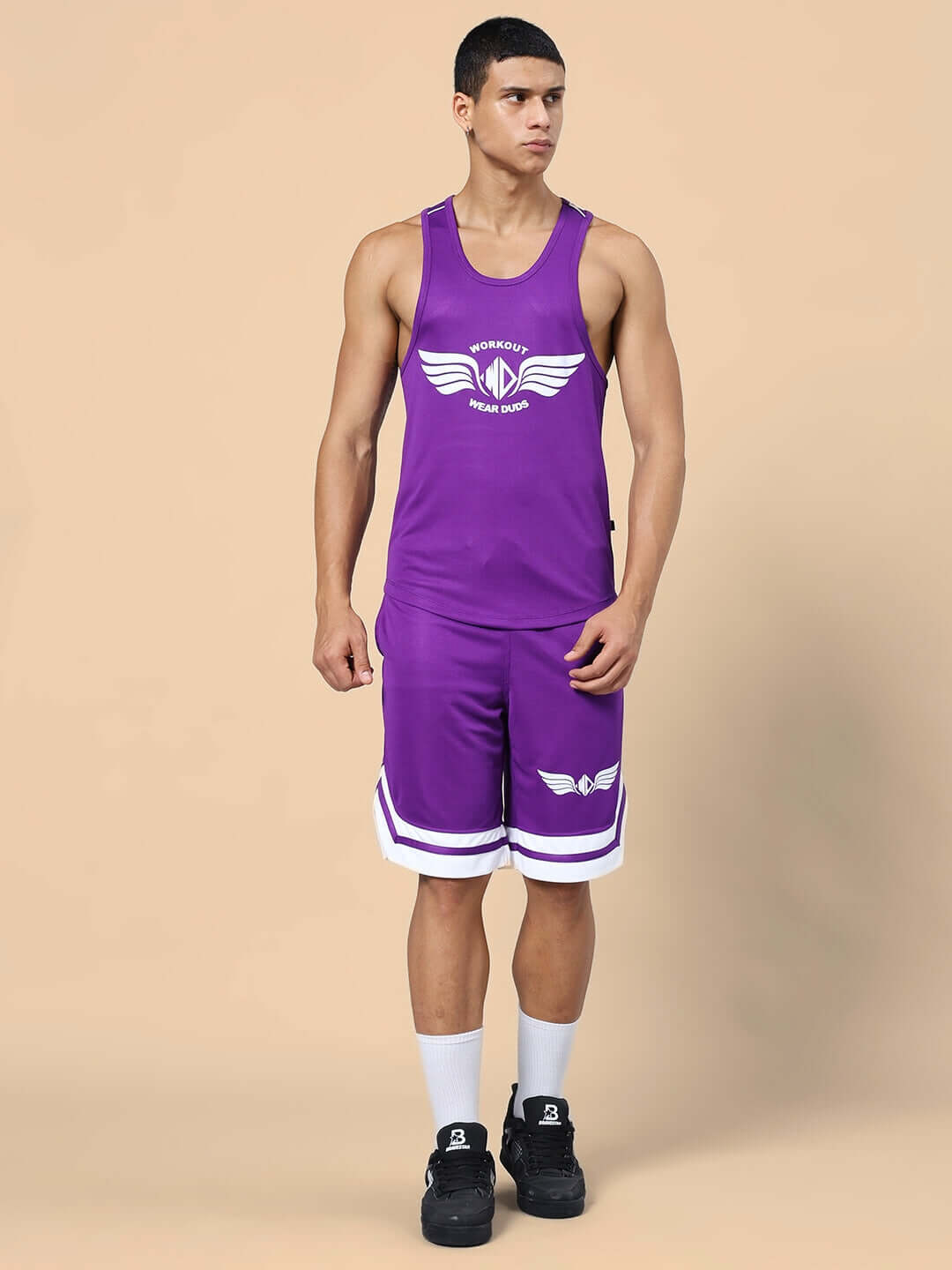 WD WINGS GYM CO-ORD SET PURPLE model wearing matching sportswear with wing logo, showcasing top and shorts for enhanced performance and style.