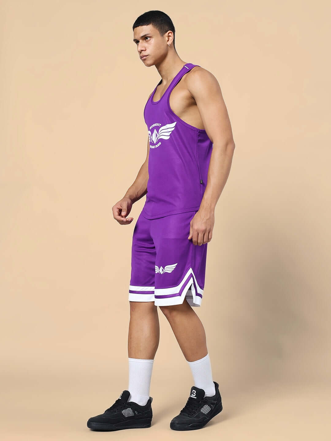 Man wearing WD WINGS GYM CO-ORD SET PURPLE, showcasing purple gym t-shirt and shorts for optimal performance and style.