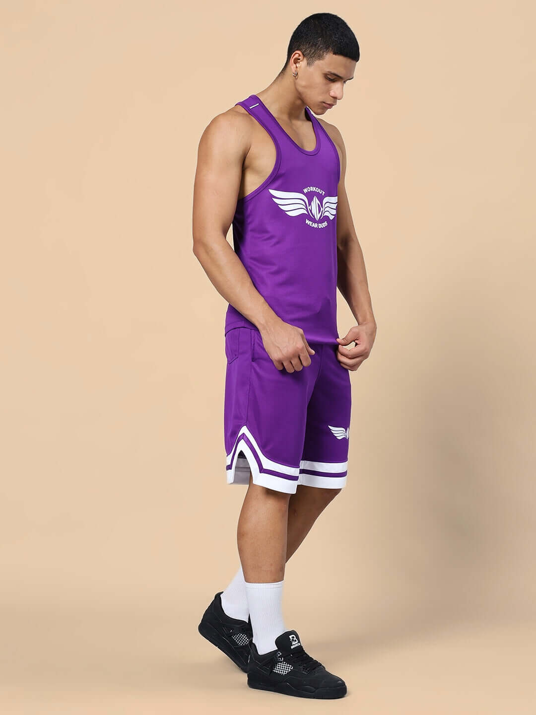 Man wearing WD WINGS GYM CO-ORD SET PURPLE, featuring tank top and shorts, ideal for workouts, showcasing fitness fashion and comfort.