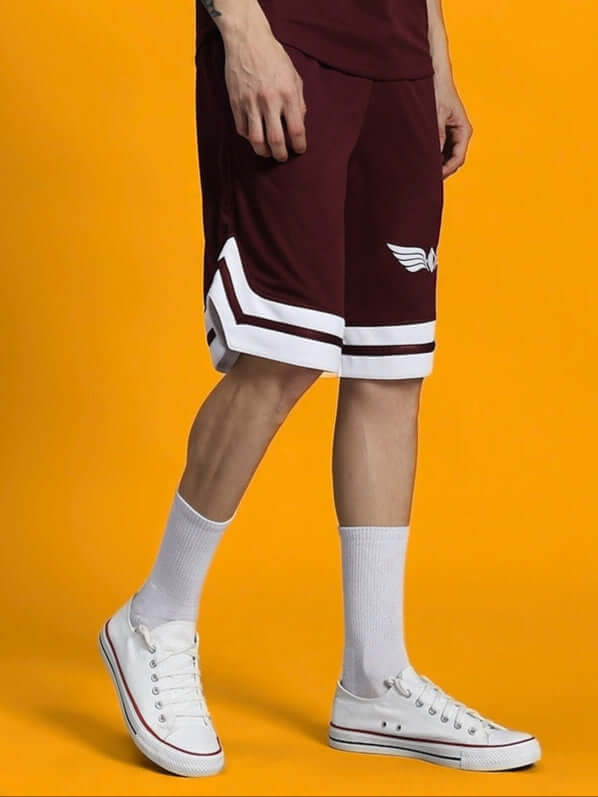 Man wearing WD Wings Regular Fit Shorts Maroon, stylish and comfortable for casual wear and active days, paired with white sneakers and socks.