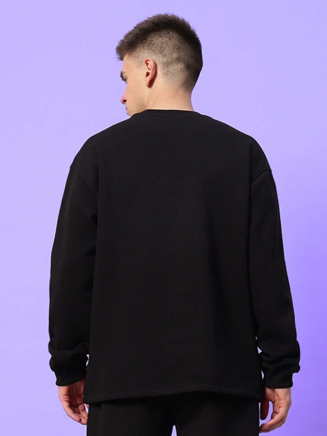 Back view of a person wearing a black sweatshirt with red accents, showcasing the WD Fireball Colorblock design against a purple background.