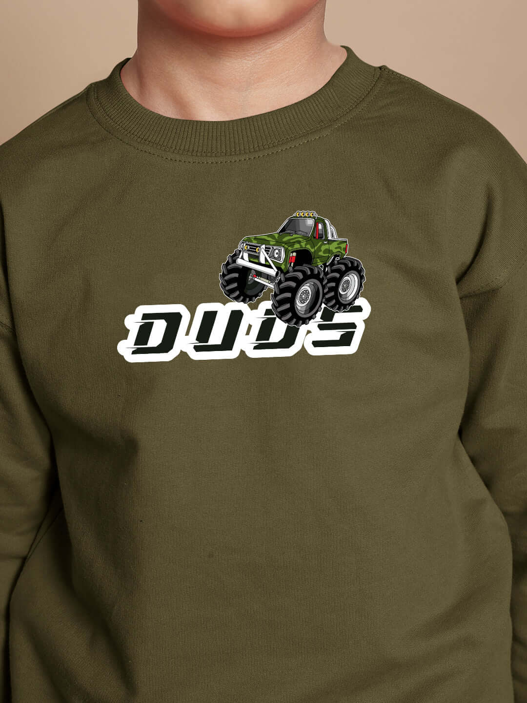 Child wearing olive green truck-themed sweatshirt with "Dude" design.