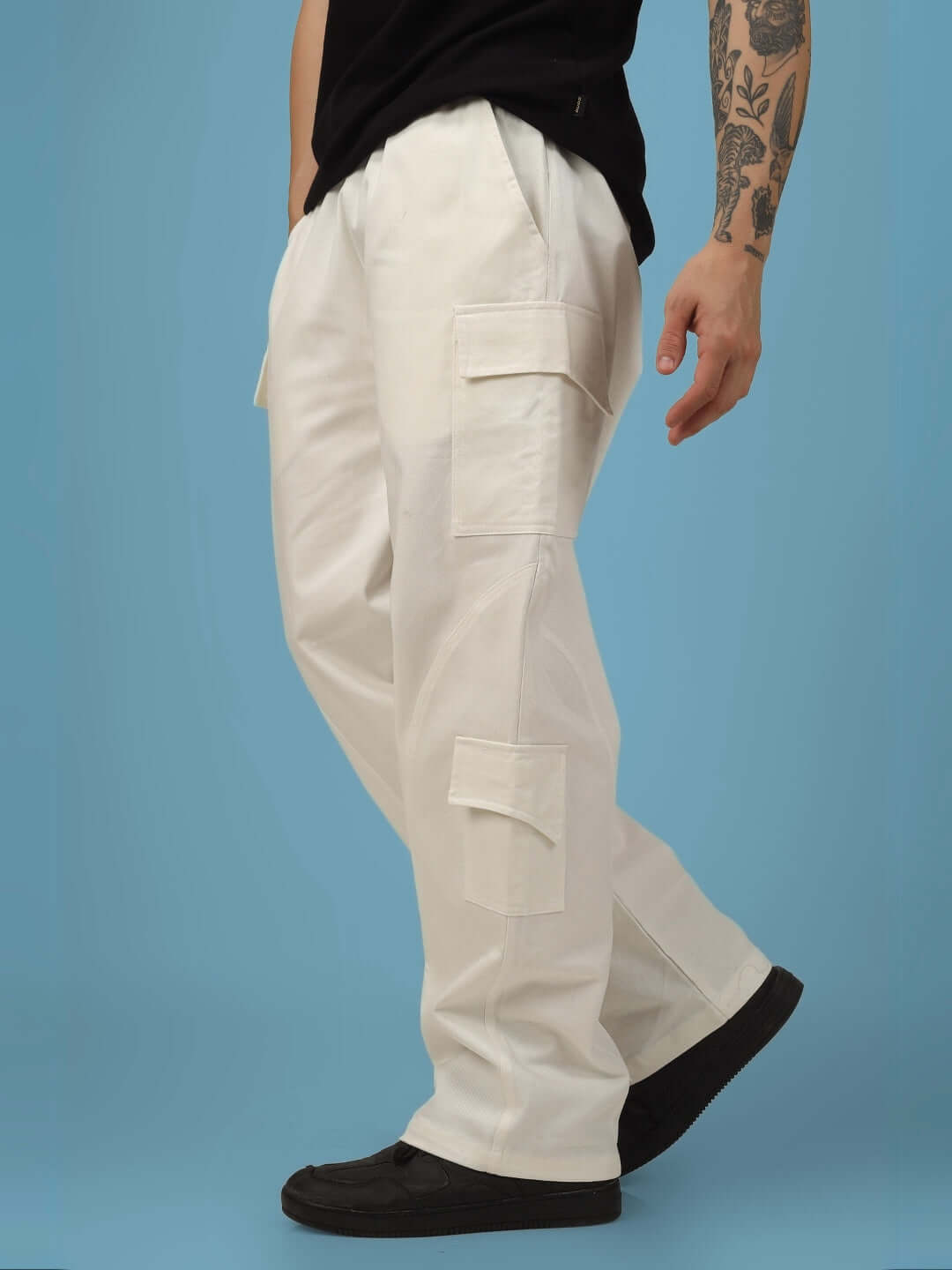 White cotton twill cargo pants with six pockets, shown on a model wearing black shoes, featuring a relaxed fit and customizable size option.