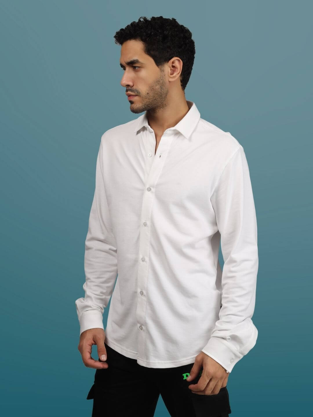 Model wearing a slim fit white sporty pique shirt with full sleeves, showcasing the stretchable and wrinkle-free fabric.