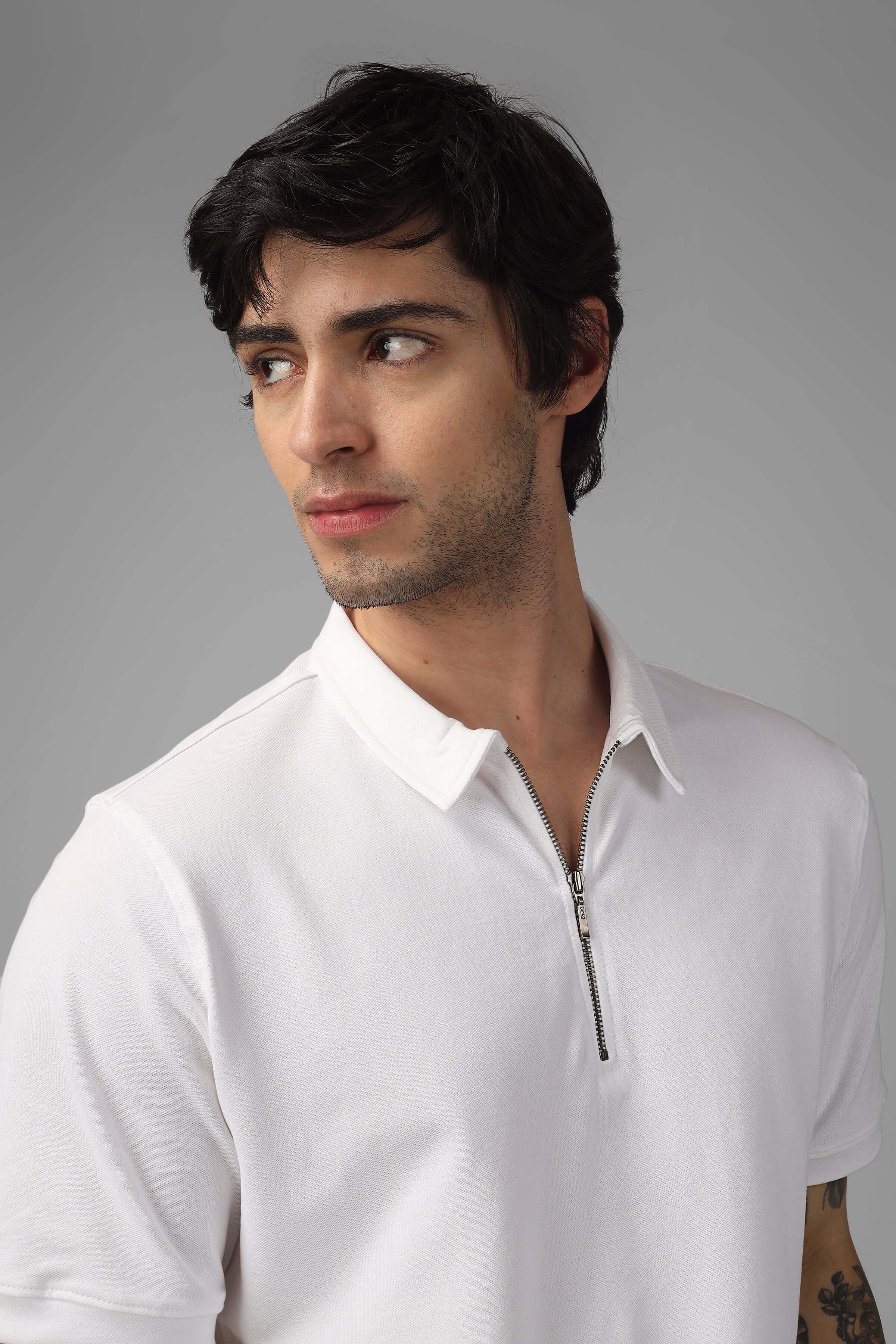 Model wearing white zipper polo neck T-shirt made from Sporty Pique Cotton Lycra, offering stretch and wrinkle-free wear.