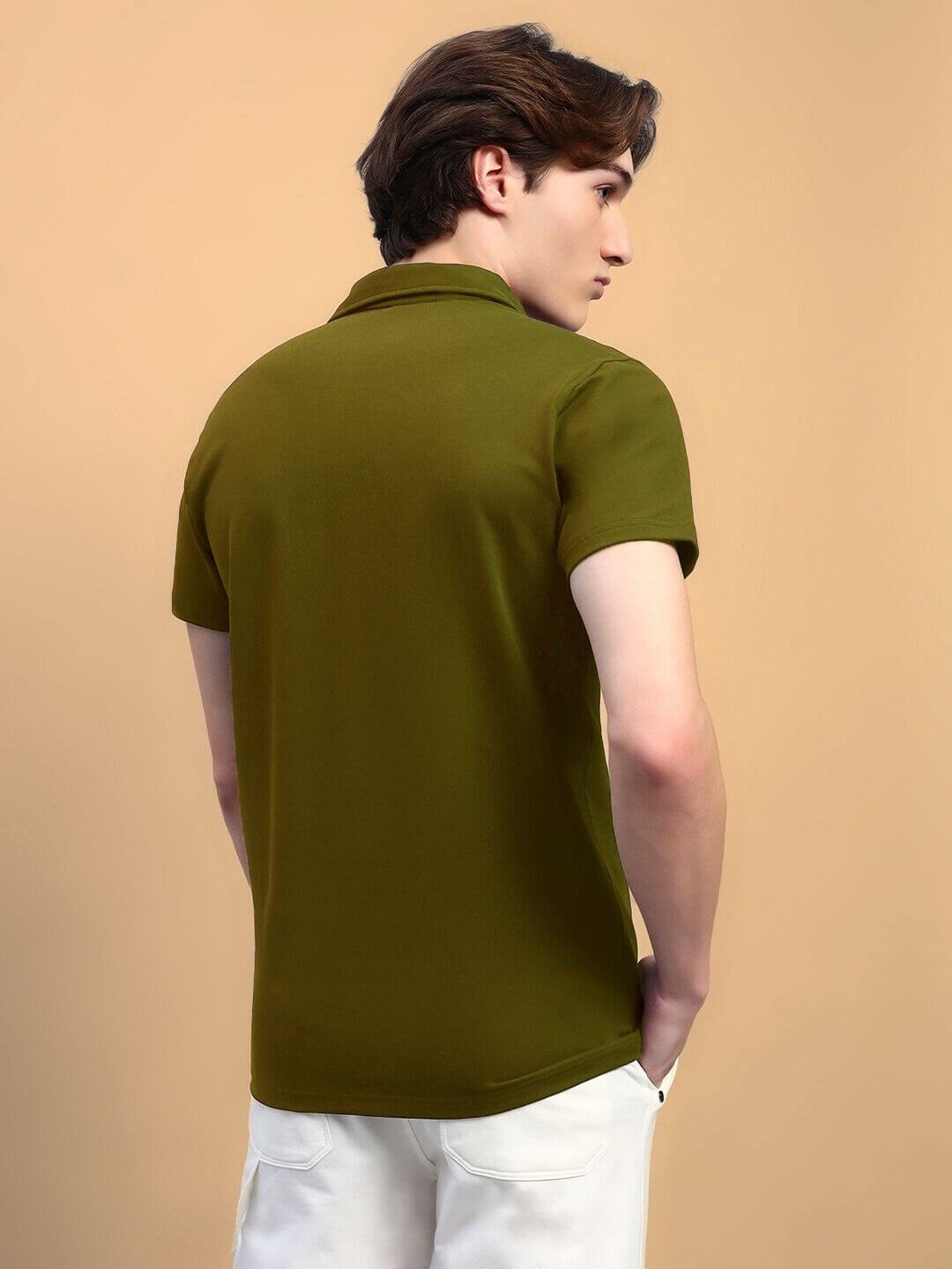 Model wearing WIDEL regular fit olive green t-shirt made of 97% cotton French Terry and 3% elastane, back view, against a beige background.