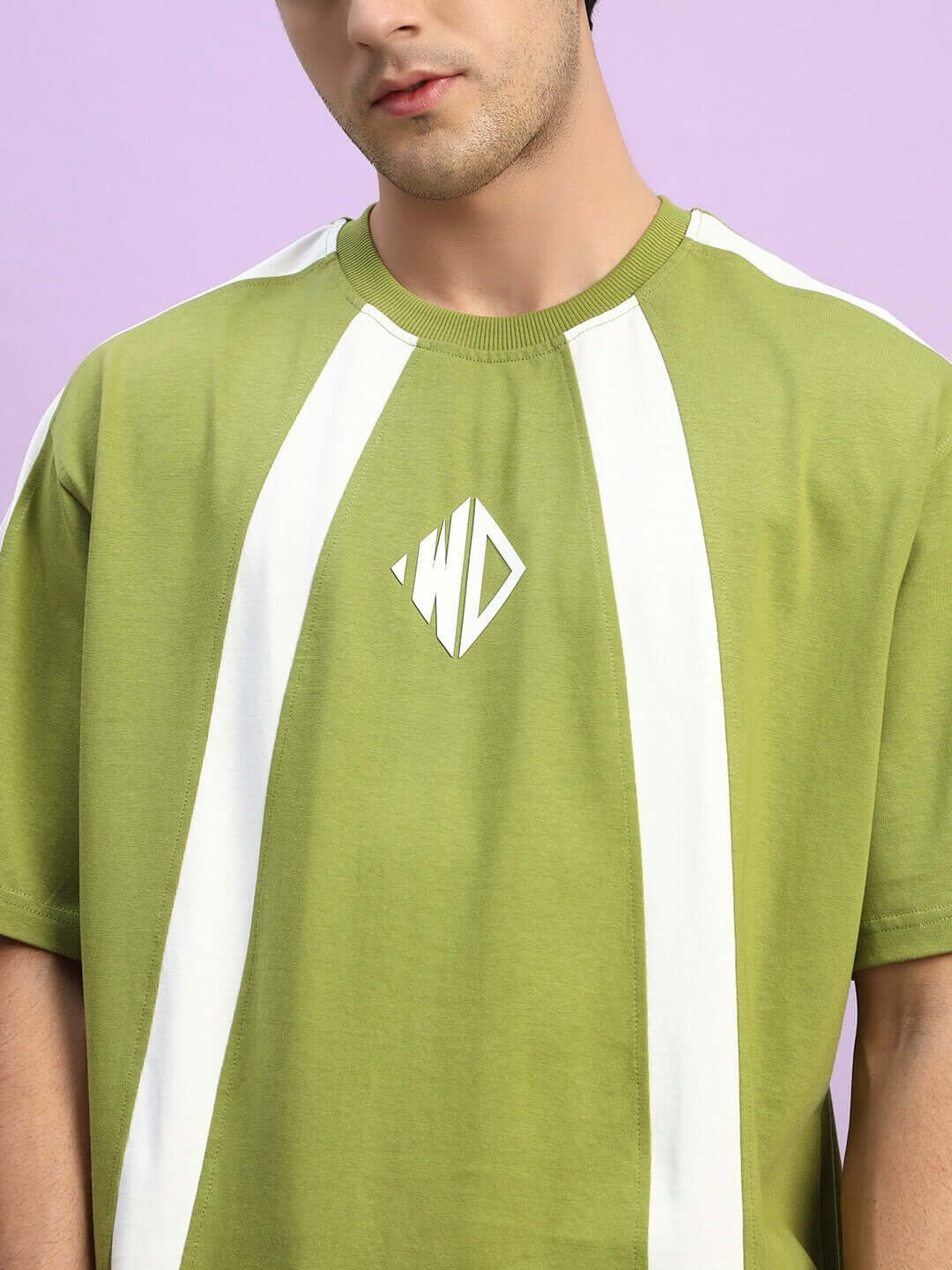 Man wearing WIDELINE OVER-SIZED T-SHIRT OLIVE GREEN with white stripe details
