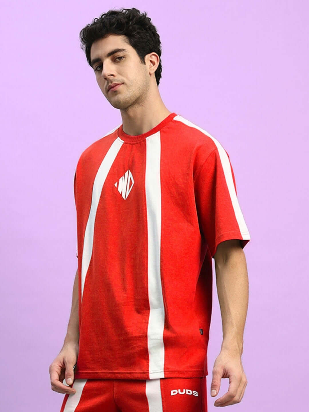 Man wearing WIDELINE OVER-SIZED T-SHIRT RED with bold streetwear look and drop shoulders, crafted from premium cotton-blend fabric.