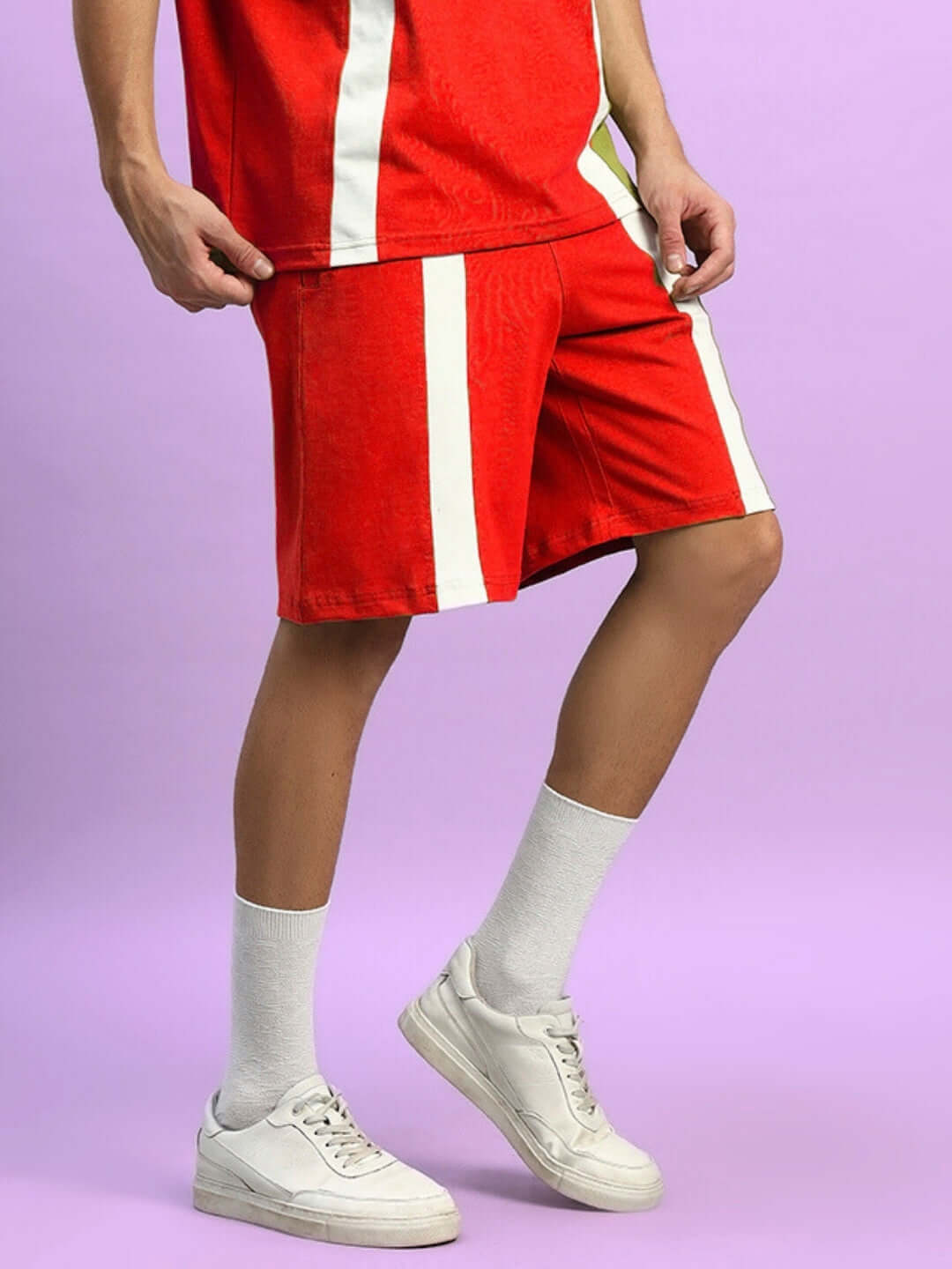 Model wearing Wideline Regular Fit Red Shorts with white stripes, customizable for custom fit, perfect for casual wear.