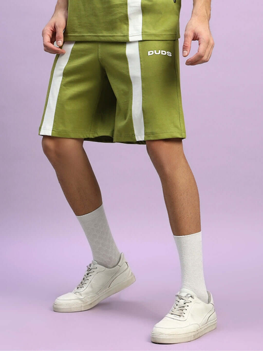 WIDELINE REGULAR FIT SHORTS OLIVE GREEN with white accents, modeled with casual shoes and socks.