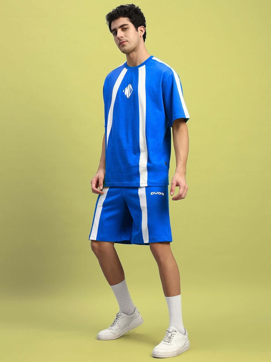 Model wearing WIDELINE SUMMER CO-ORD SET ROYAL BLUE showcasing oversized t-shirt and shorts made from premium cotton-blend fabric.