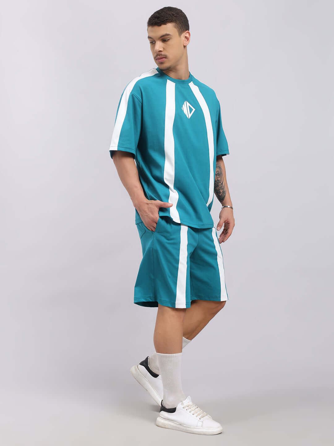 Man wearing WIDELINE SUMMER CO-ORD SET TEAL with teal and white stripes, featuring a premium heavy gauge fabric and bio-washed cotton.