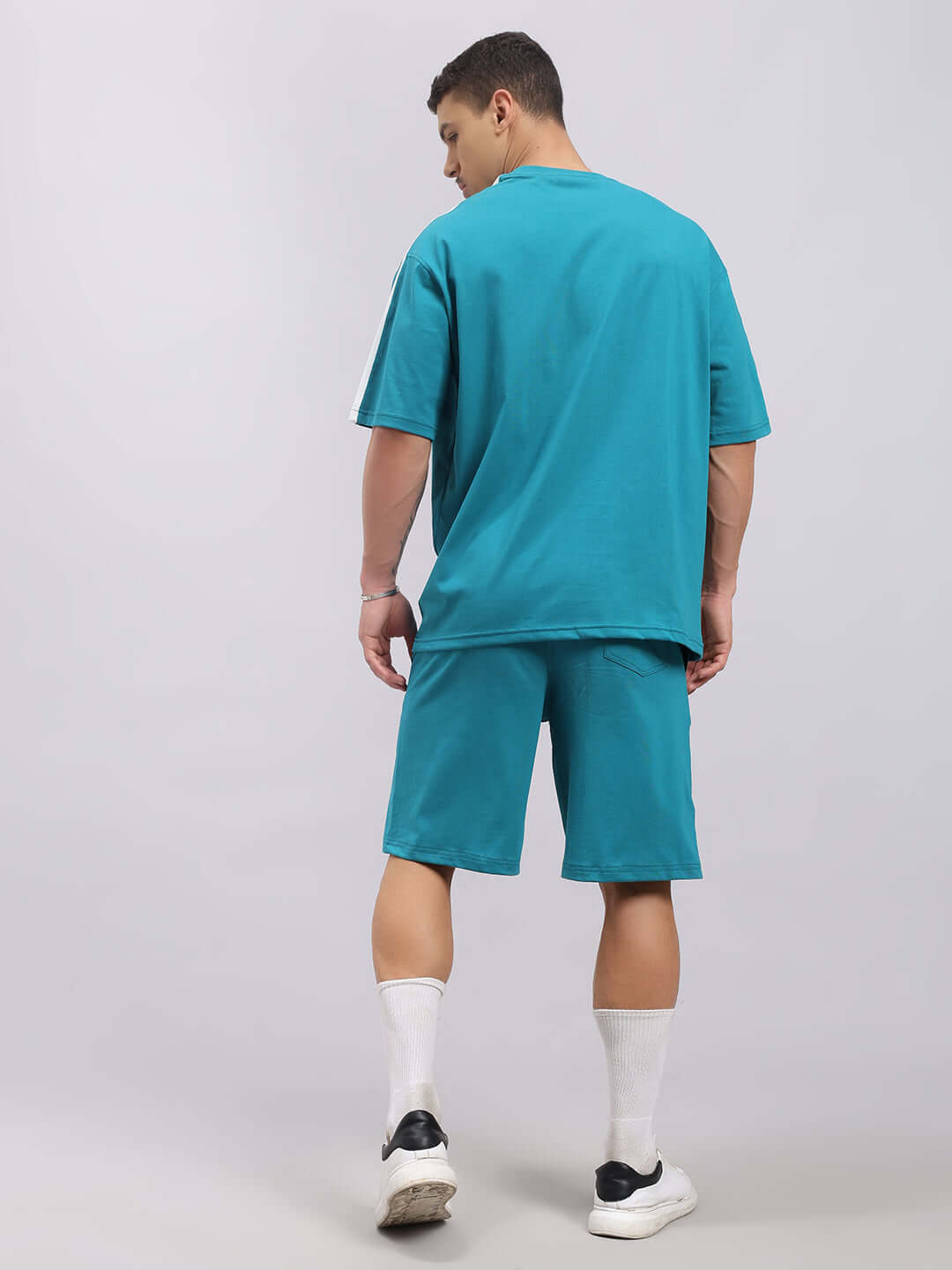 Back view of model wearing WIDELINE SUMMER CO-ORD SET TEAL in premium cotton fabric.