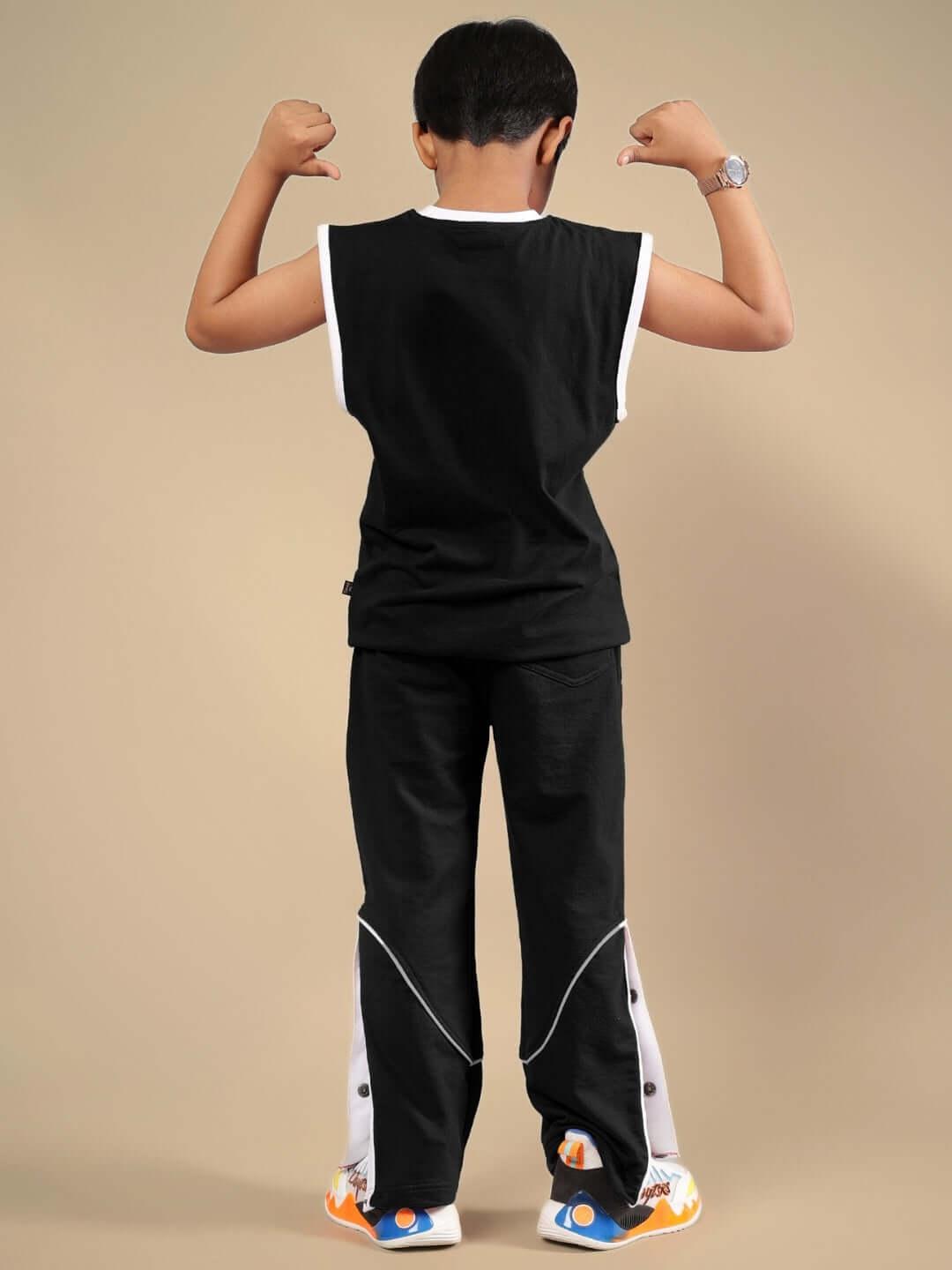 Child modeling Wild Planet black co-ord set, featuring sleeveless top and matching pants. Suitable for boys and girls.