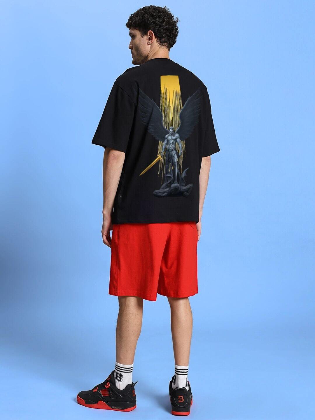 Model wearing WINGED WARRIOR PRINTED OVERSIZED CO-ORD SET BLACK RED with striking graphic design.