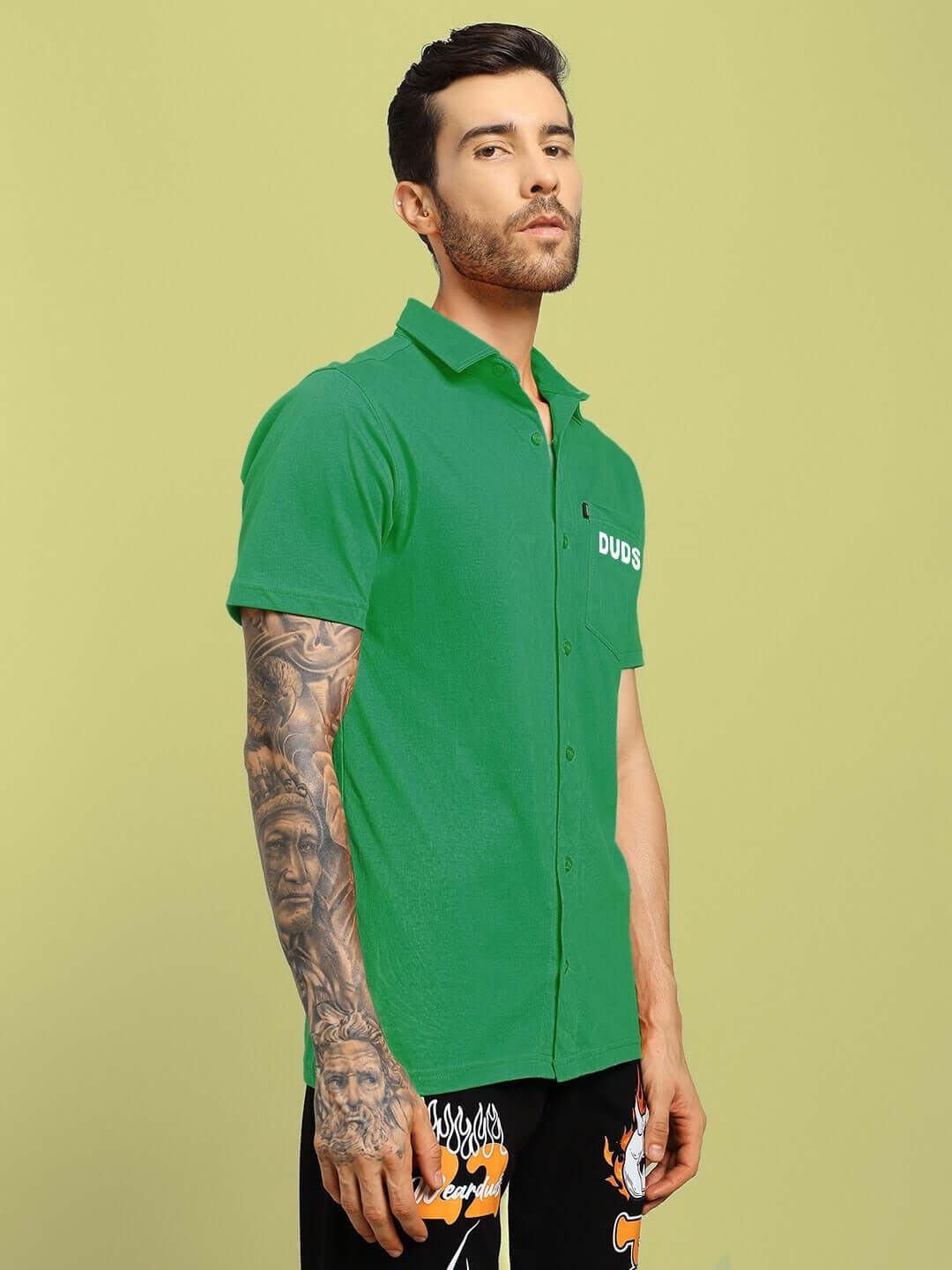 Man wearing green WINGS TEE regular fit shirt by DUDS, showcasing the shirt's stylish design and comfort.