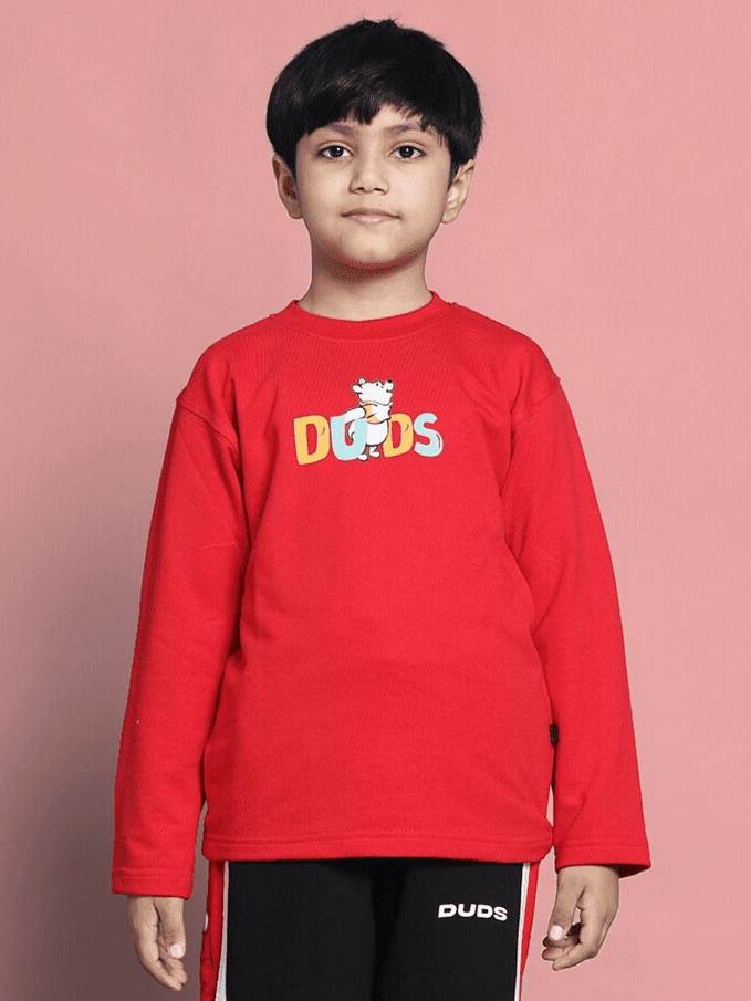 Child wearing WINNIE OVERSIZED SWEATSHIRT BOYS GIRLS RED, featuring a vibrant color and playful bear-inspired design, perfect for cozy comfort.