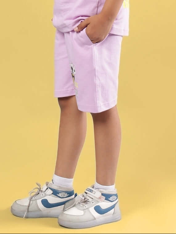 Child wearing WOLF PACK SHORTS FOR BOYS & GIRLS LILAC, showcasing style and comfort in casual footwear.