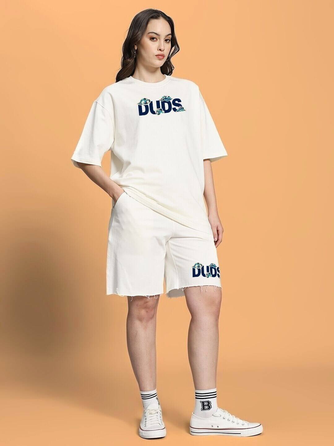 Woman wearing WOMEN CLOUD PRINTED CO-ORD SET OFF WHITE with relaxed-fit top and shorts on orange background