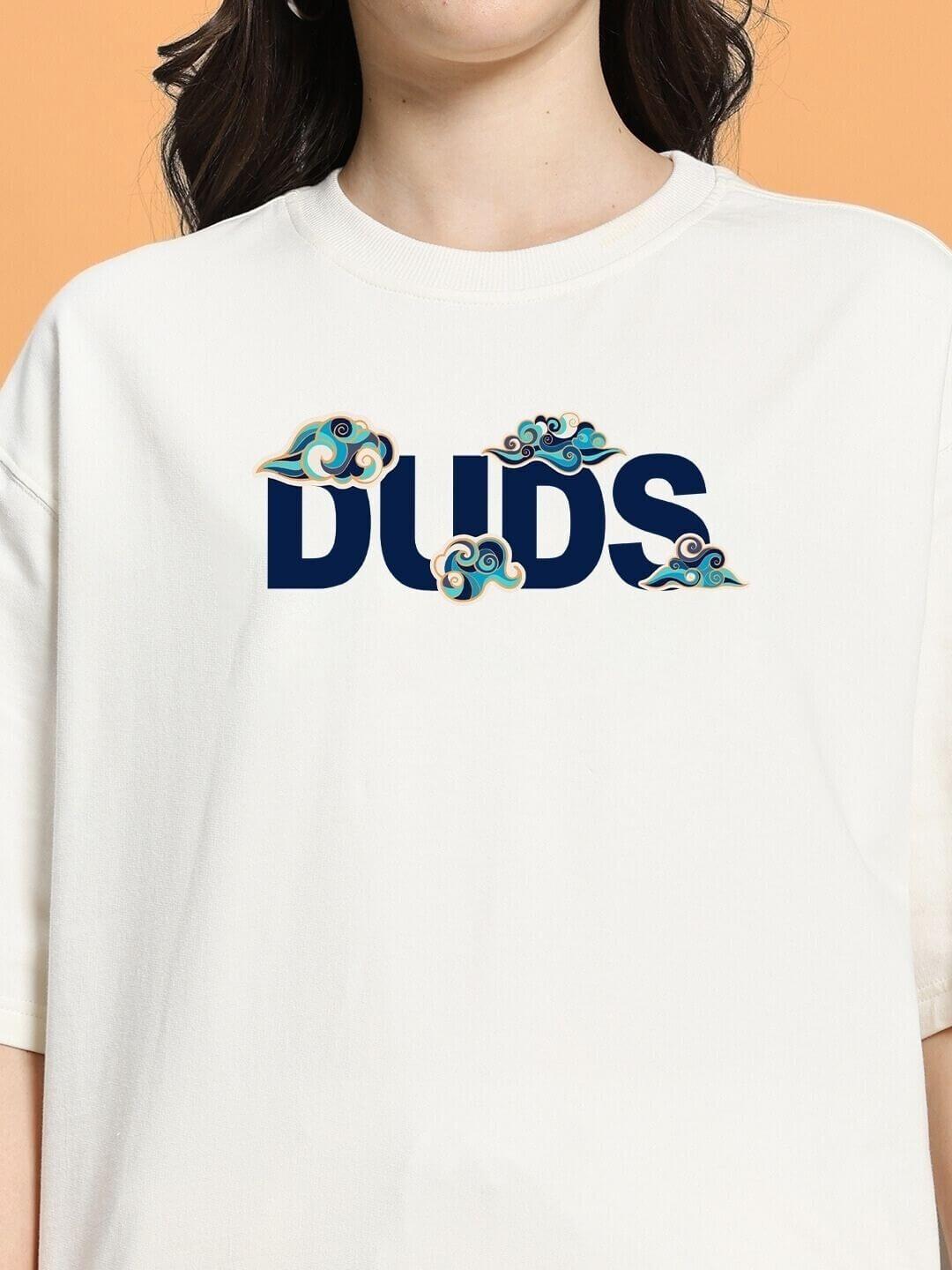 Close-up of a white T-shirt with bold 'DUDS' text and colorful cloud designs, part of WOMEN CLOUD PRINTED CO-ORD SET OFF WHITE collection.