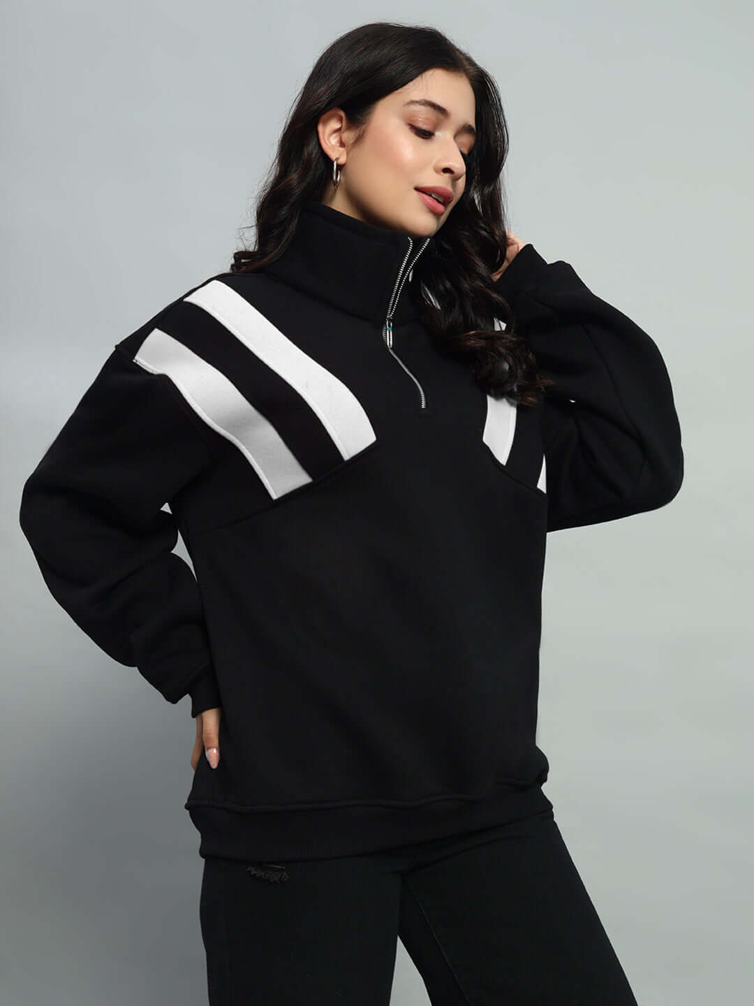 Woman wearing black-white colorblock crossbar fleece jacket