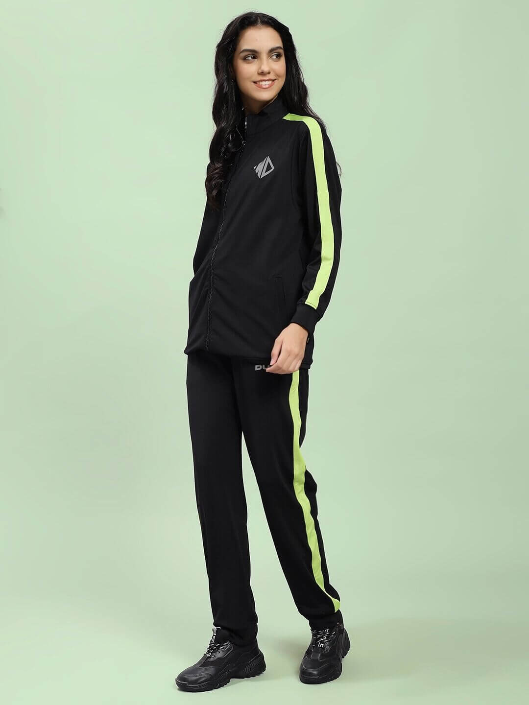 Model wearing WOMEN HIGH PERFORMANCE CO-ORD SET BLACK with neon stripes, showcasing athleisure style.