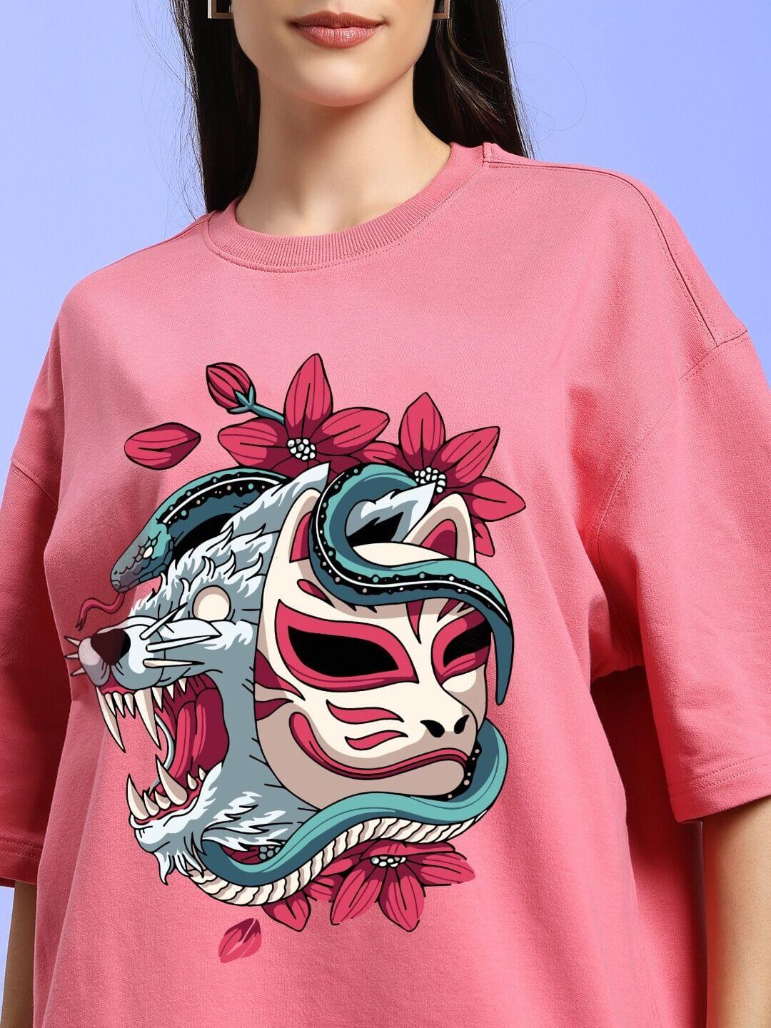 Model wearing WOMEN KITSUNE WOLF PRINTED OVERSIZED T-SHIRT PINK with fierce wolf and mask print on pink fabric.