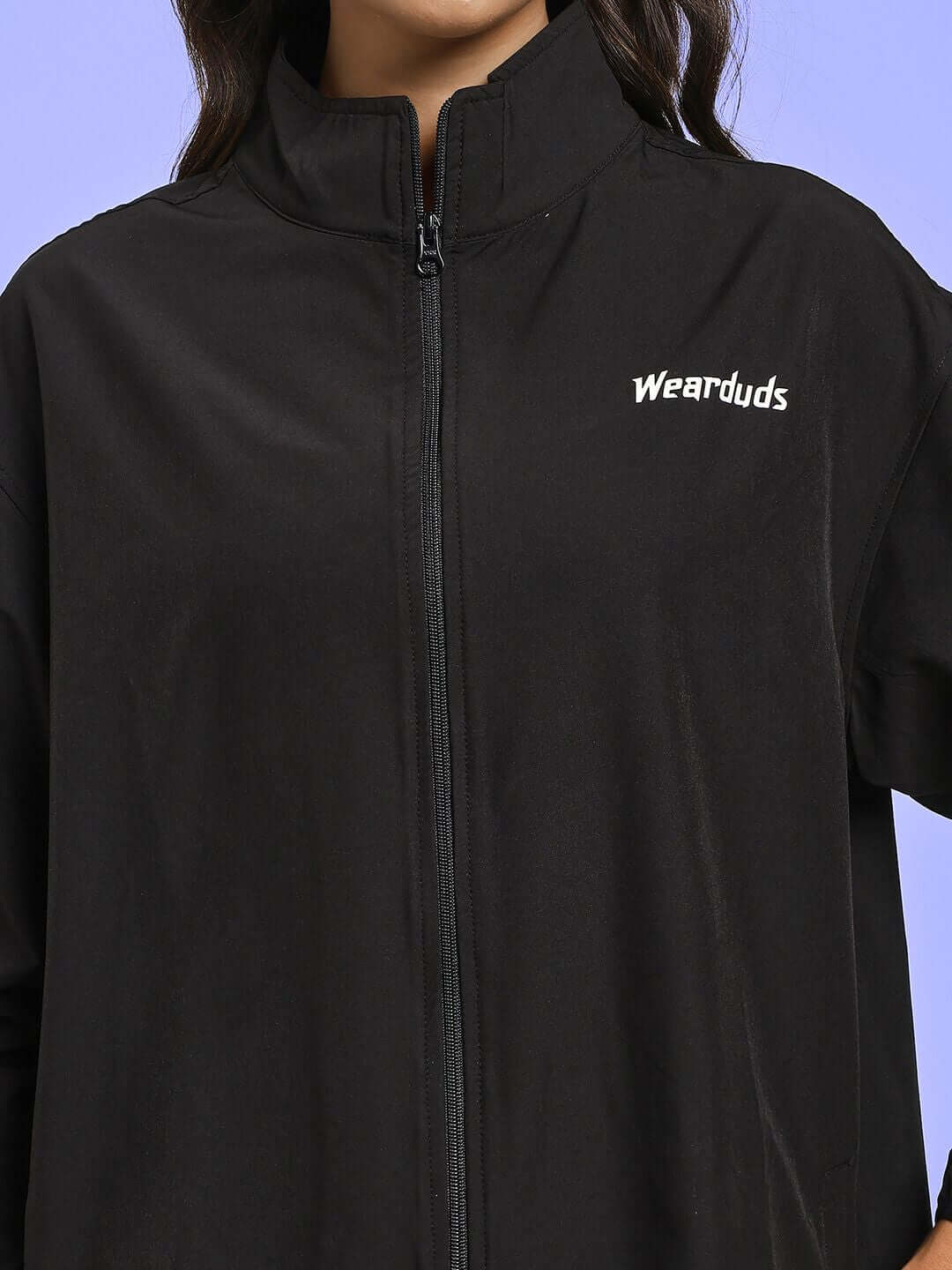 Close-up of WOMEN RELIGHT RELAXED FIT CO-ORD SET BLACK with zip and logo detail