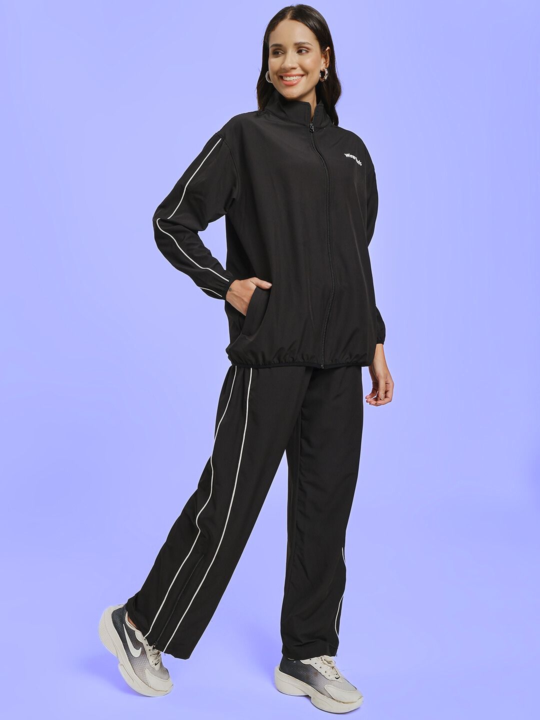 Woman wearing WOMEN RELIGHT RELAXED FIT CO-ORD SET BLACK with sleek black design, displaying comfort and style.
